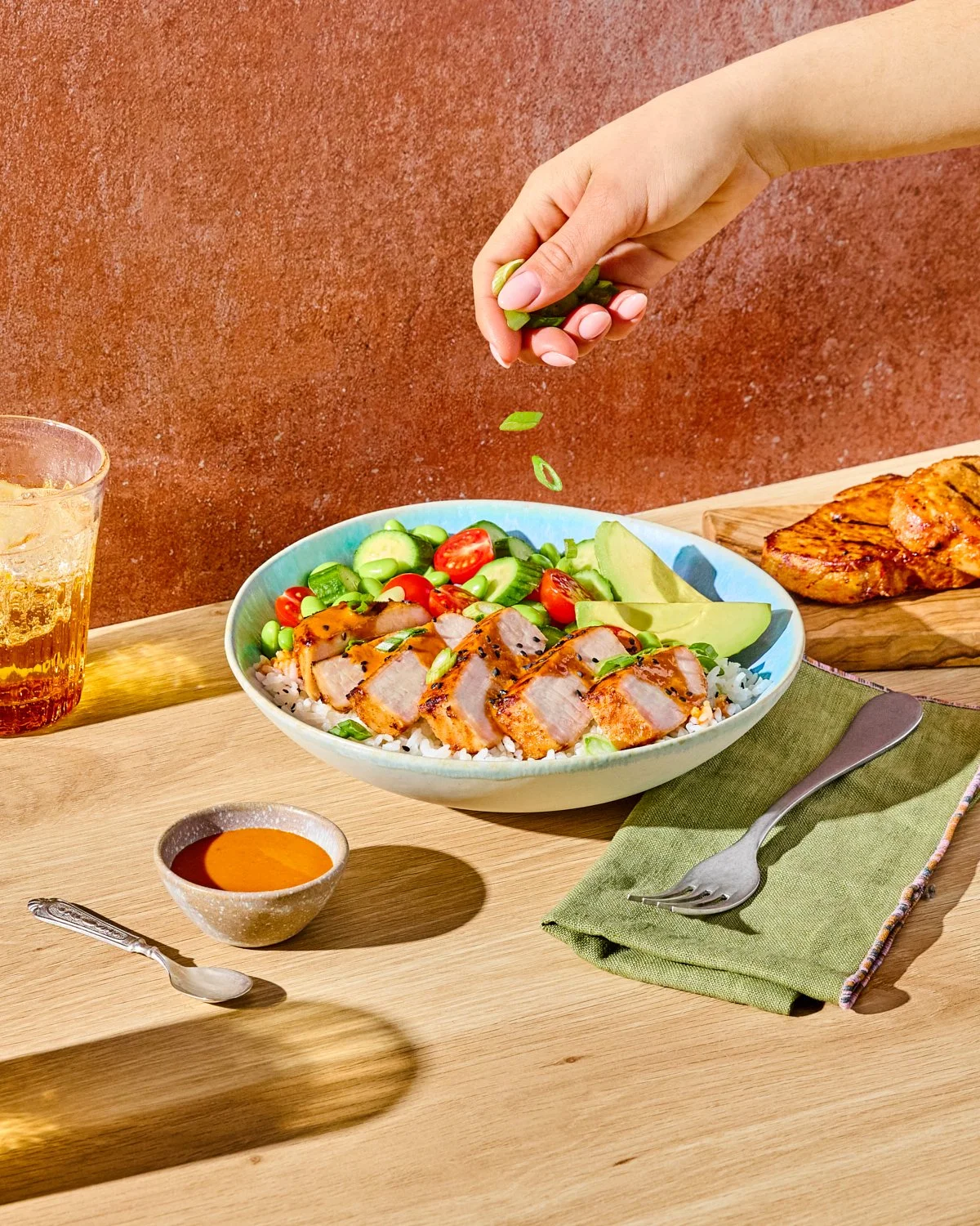 Tahini marinated grilled pork chop bowl with colorful vegetables for National Pork Board.