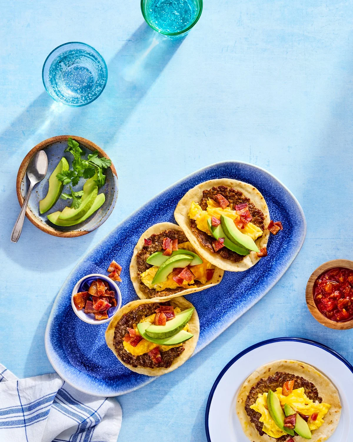 Breakfast smash tacos with sausage, eggs, avocado, and salsa for National Pork Board.