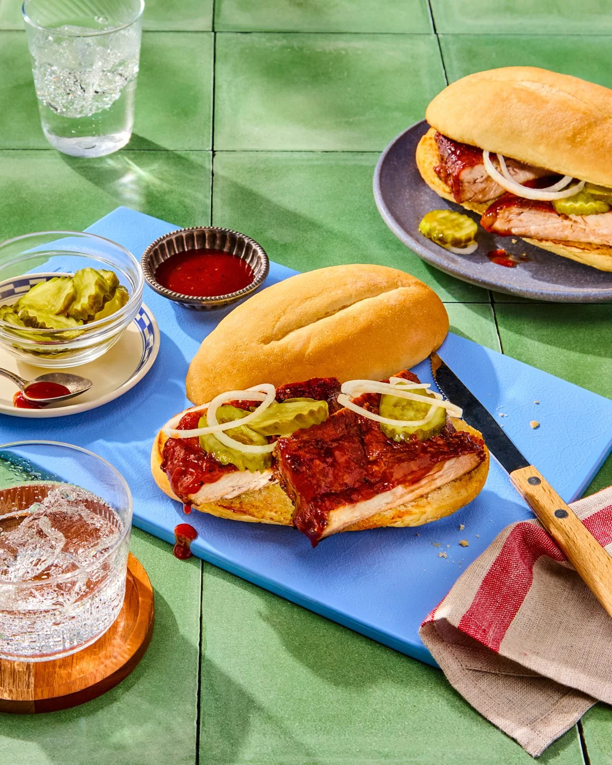 Slow cooked rib sandwich with pickles and sauce for National Pork Board recipe photography.