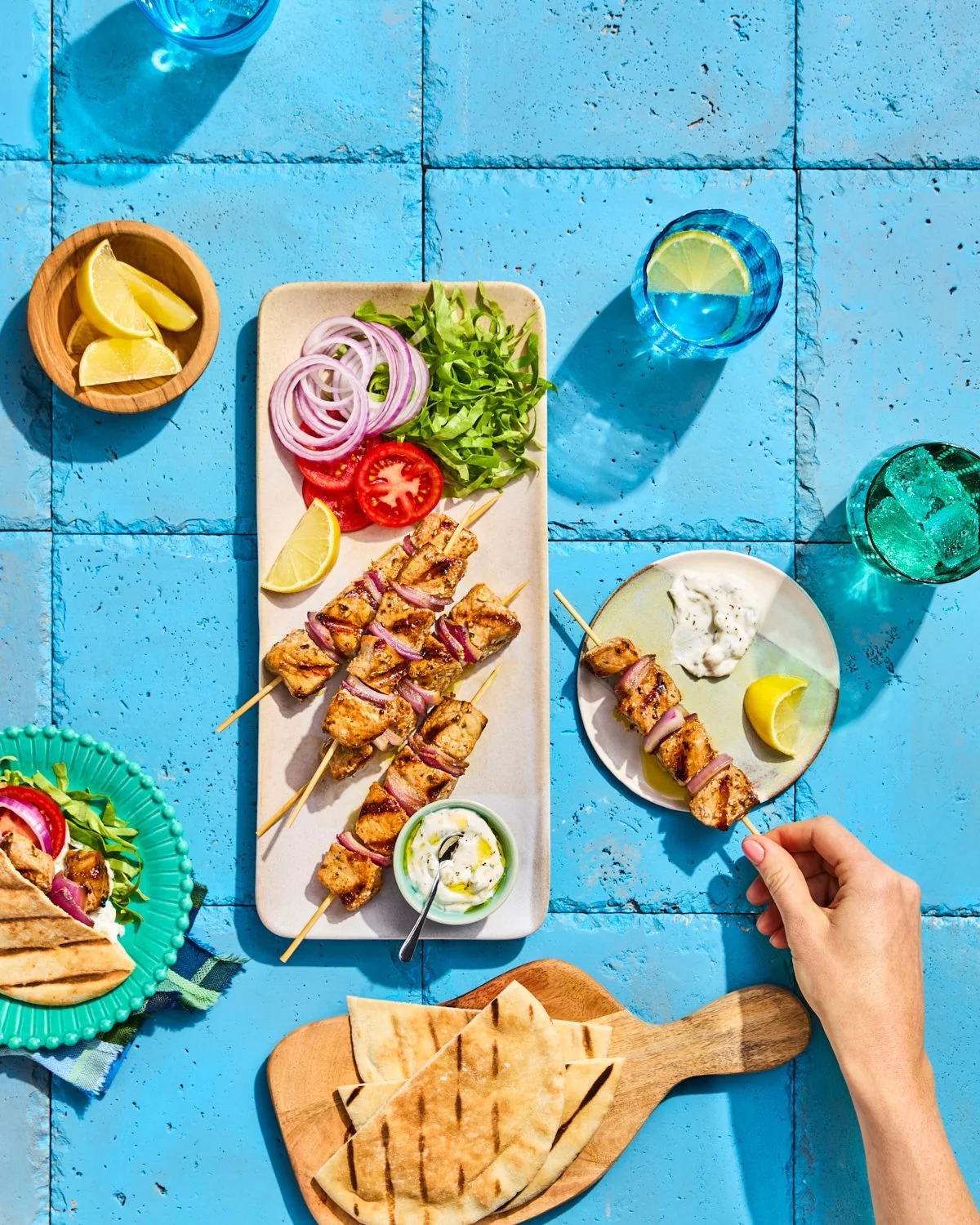 Pork souvlaki skewers with pita, onions, and tzatziki for National Pork Board.