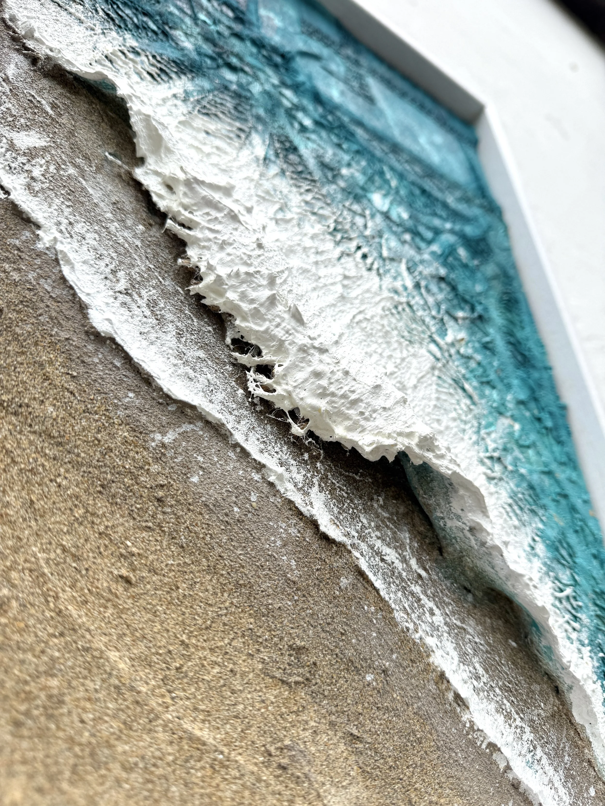 Closeup of 3d texture of the wave sculpted with surfboard fibreglass offcuts
