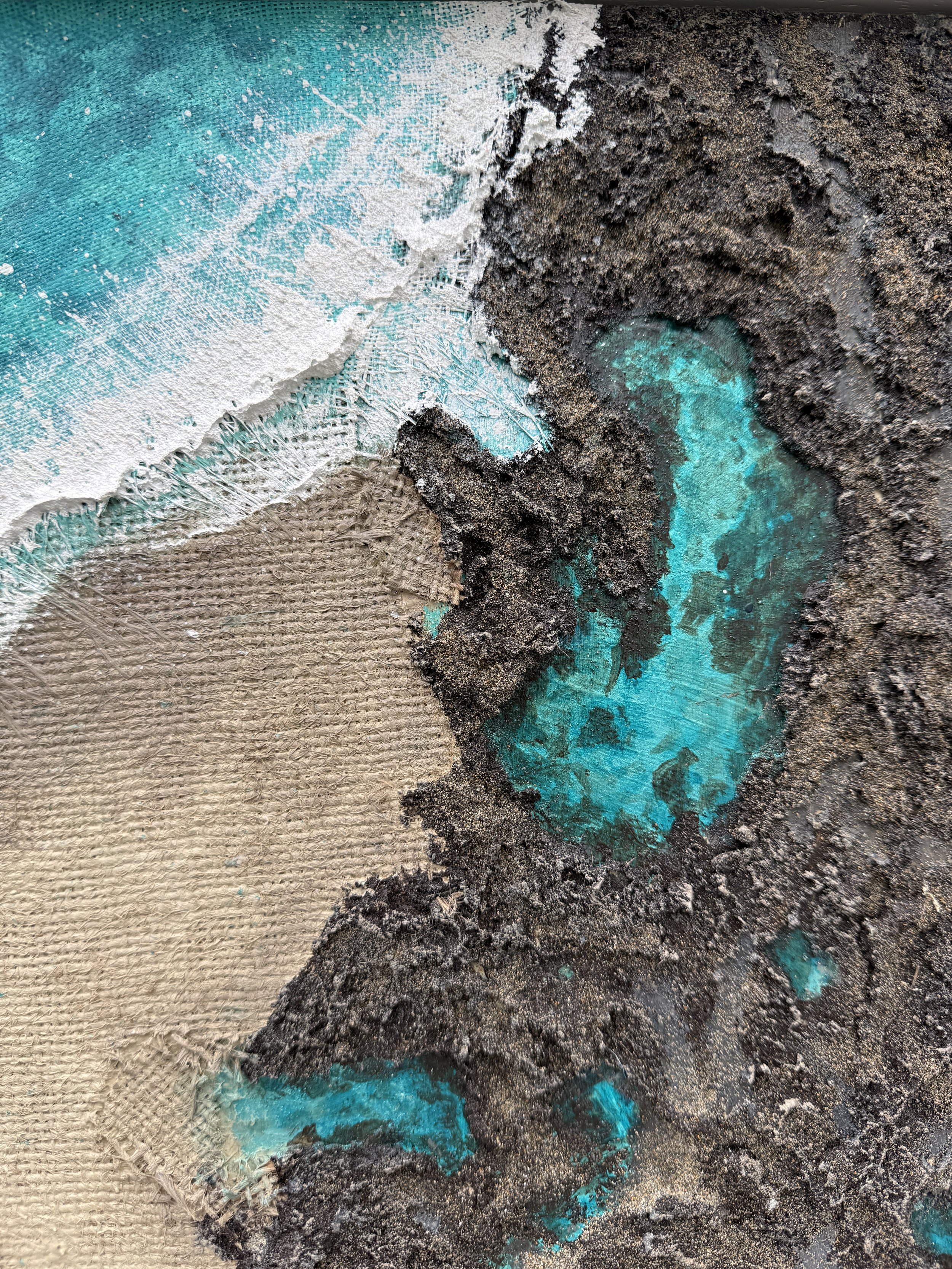 Close-up of rocks made from beach-found rope and net around the turquoise sea pool in Held by the Rocks