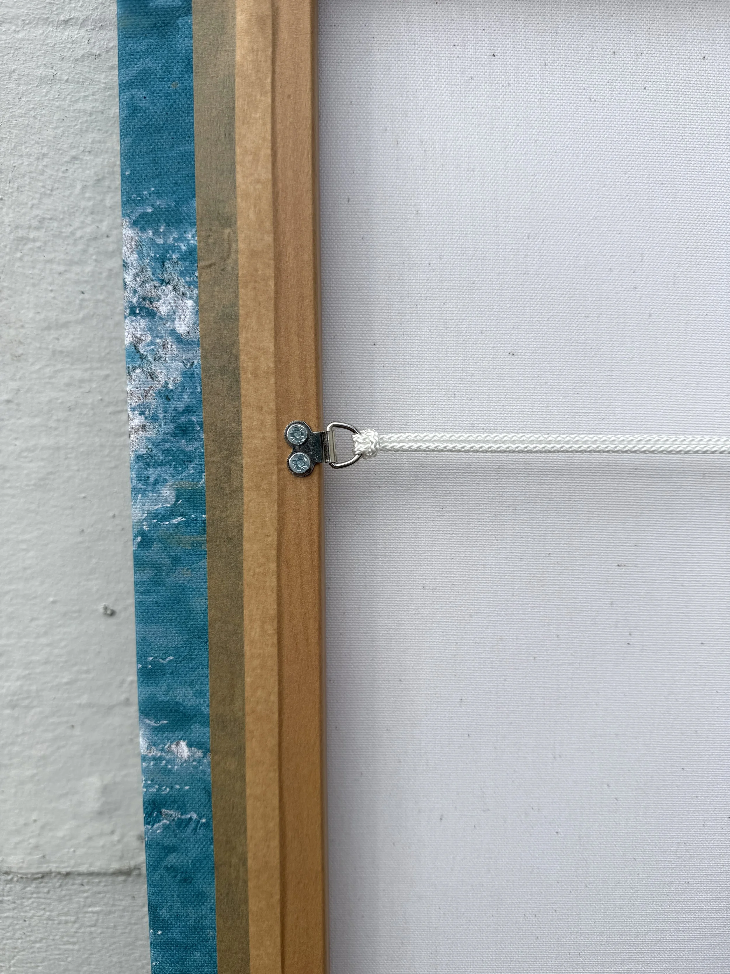 Back of the Paddle Out canvas showing the hand-stretched frame and hanging cord