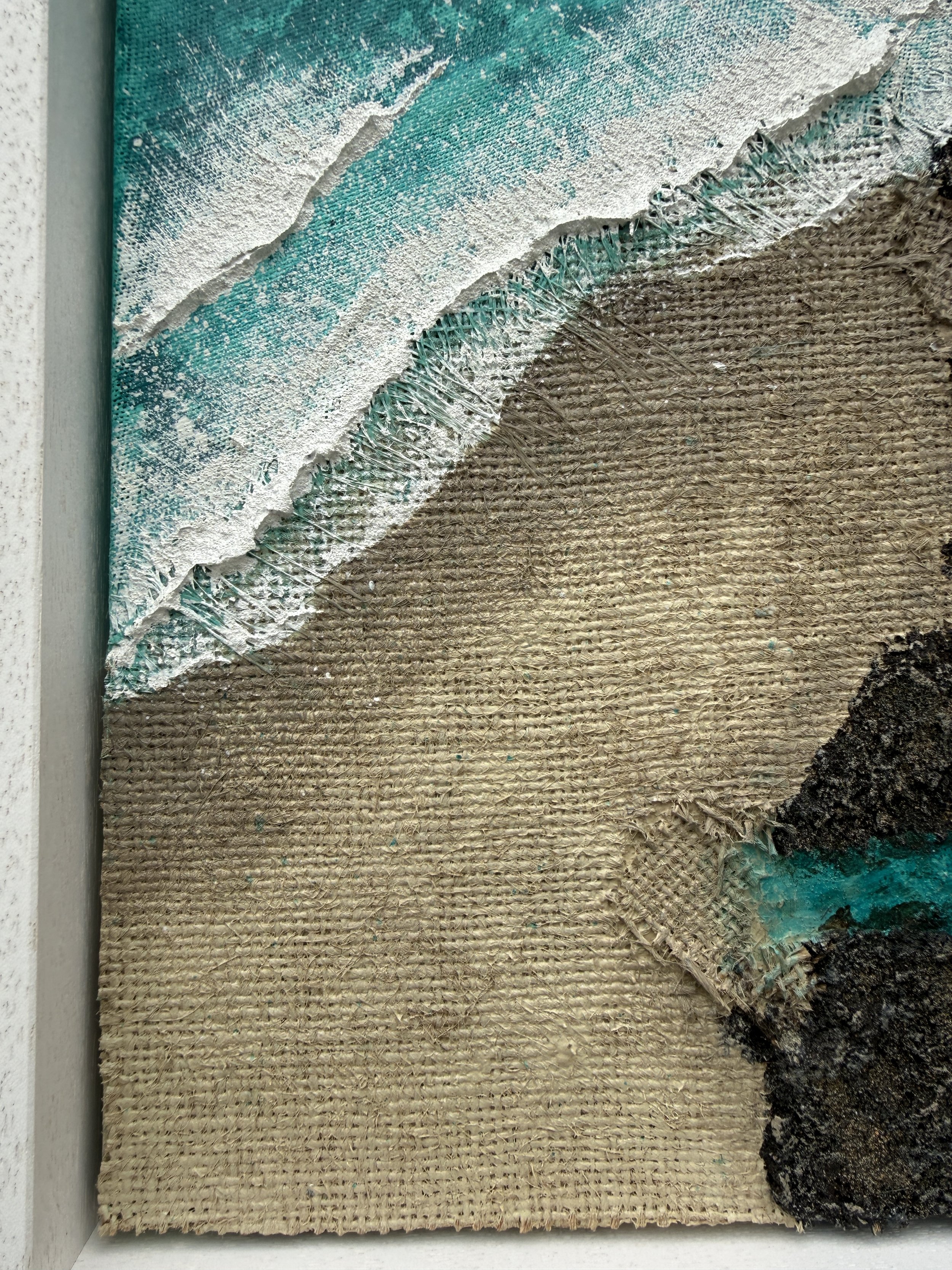 Close-up of hessian sack sand and surfboard fibreglass wave in Held by the Rocks