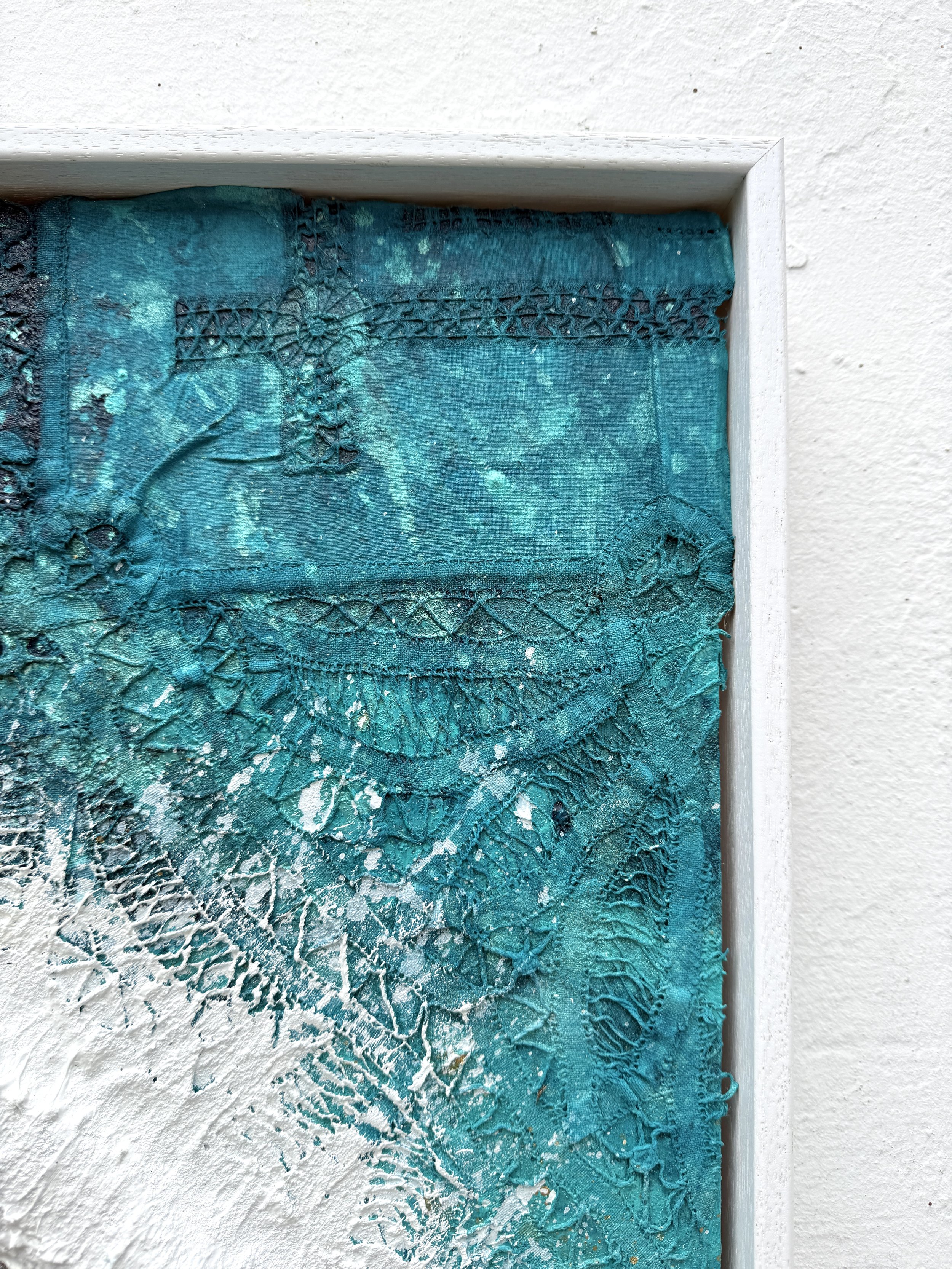 Close-up of lace from the artist’s grandmother’s tablecloth and sculpted white water in Woven in the Waves II
