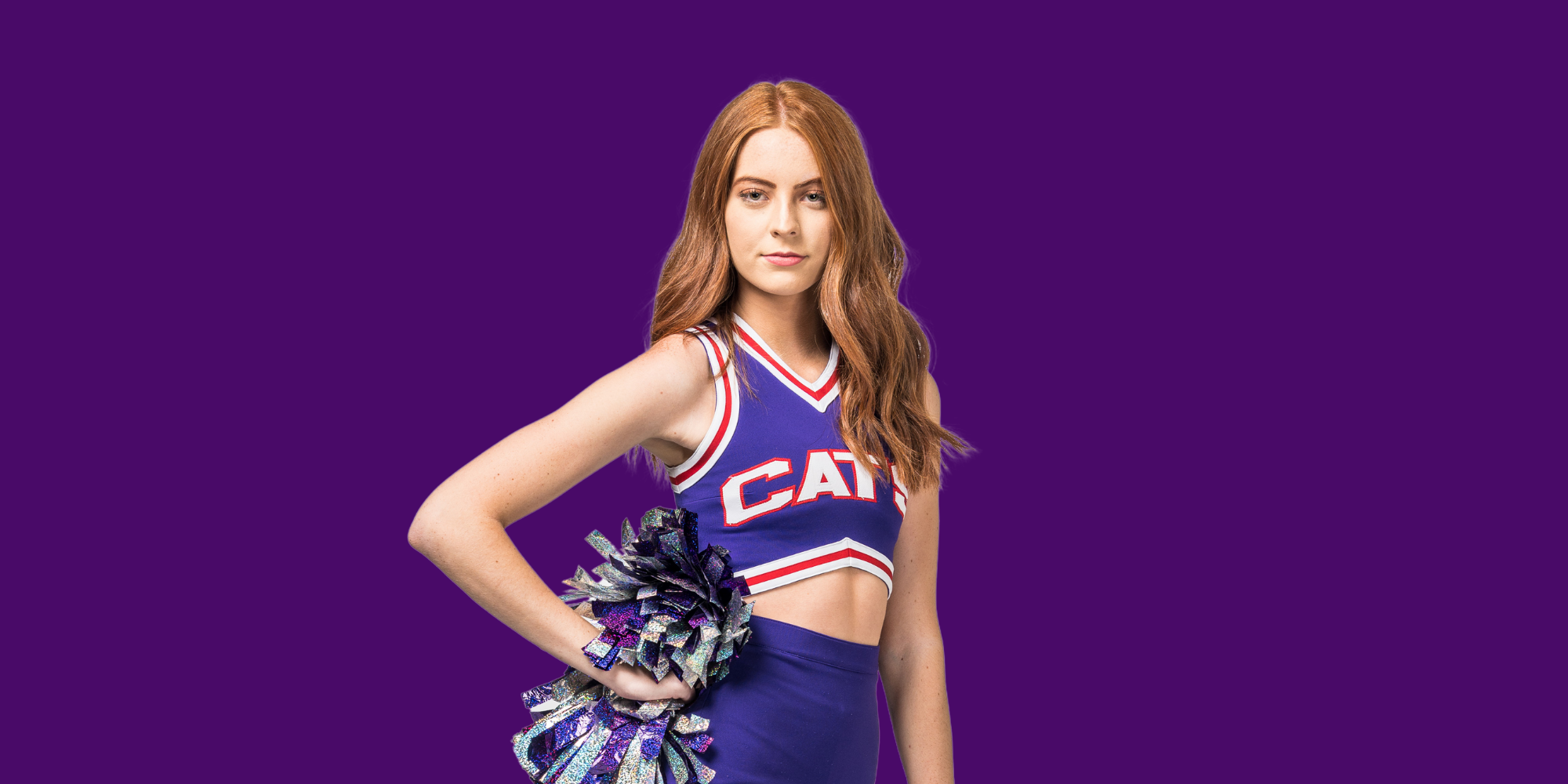 A young woman in a cheerleading uniform holding pom-poms against a purple background.