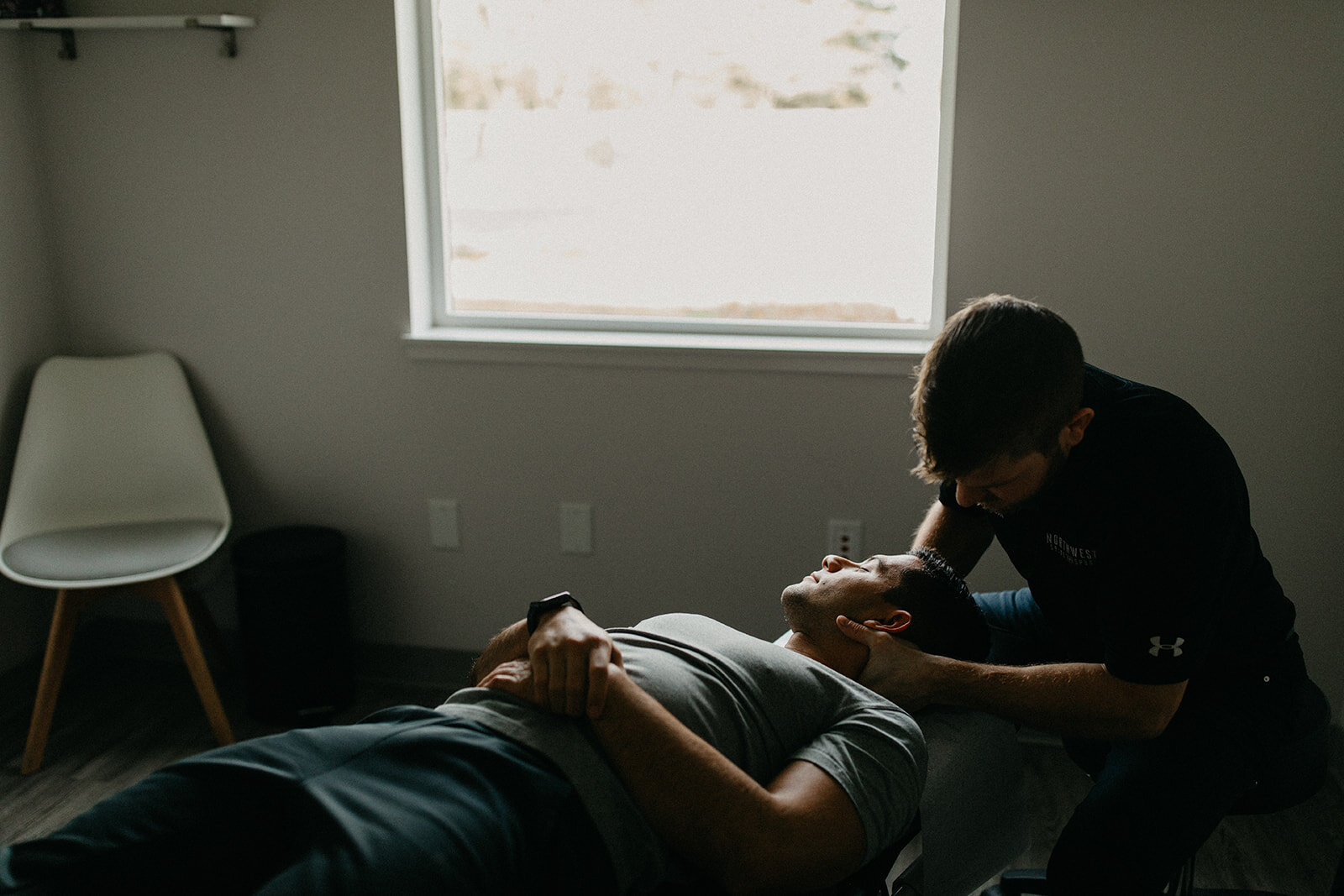 Dr. Trevor Stauber adjusts a patient's neck at his clinic in McMinnville, Oregon.
