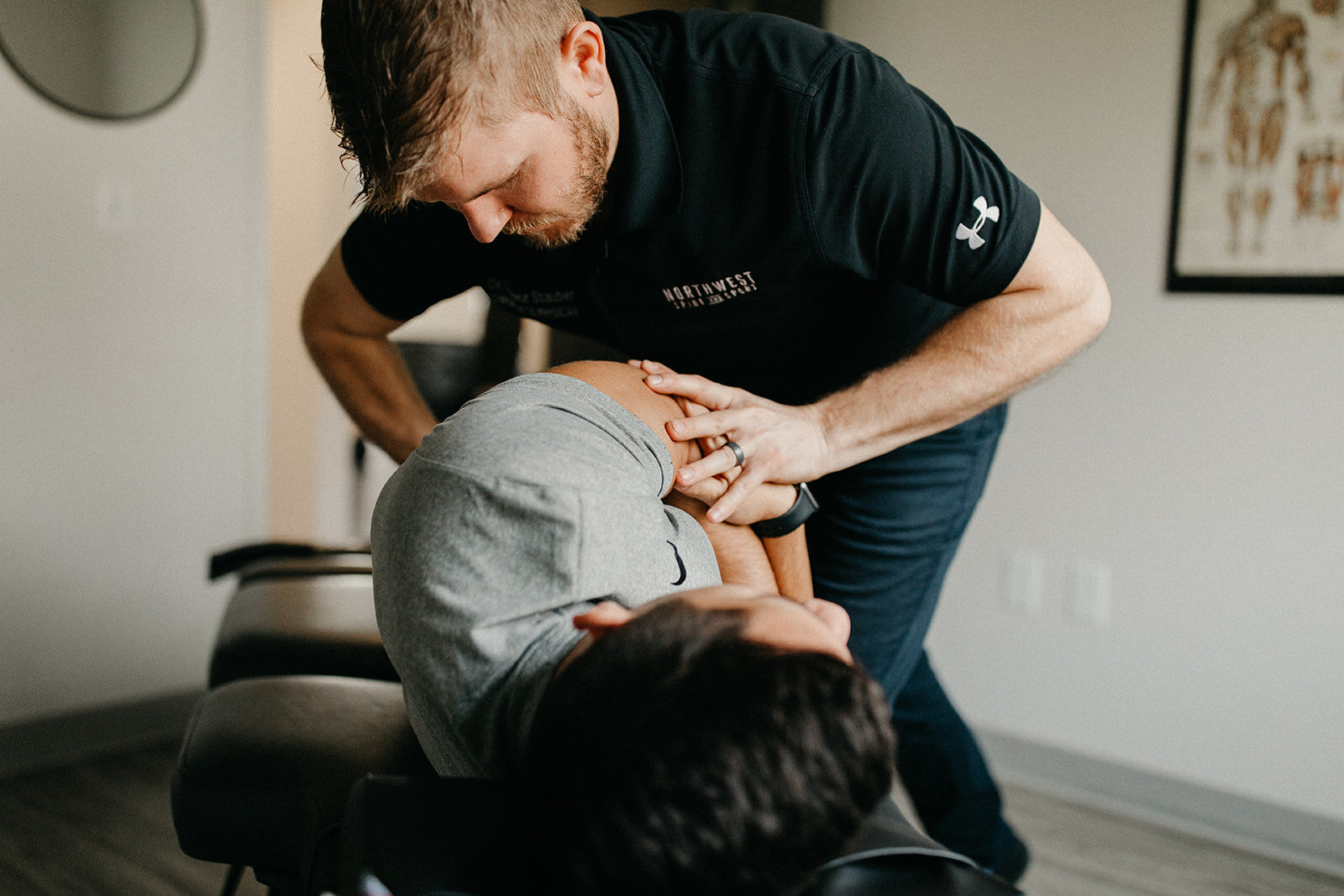 Dr. Trevor Stauber adjusts a patient's spine at his clinic in McMinnville, Oregon.