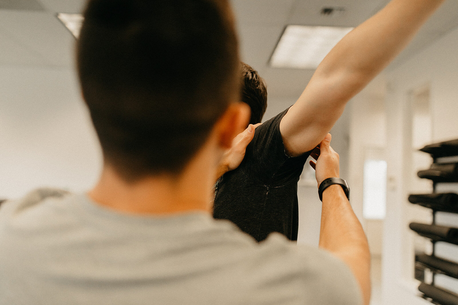 A mobility specialist training a patient's shoulder to move correctly through FRC.