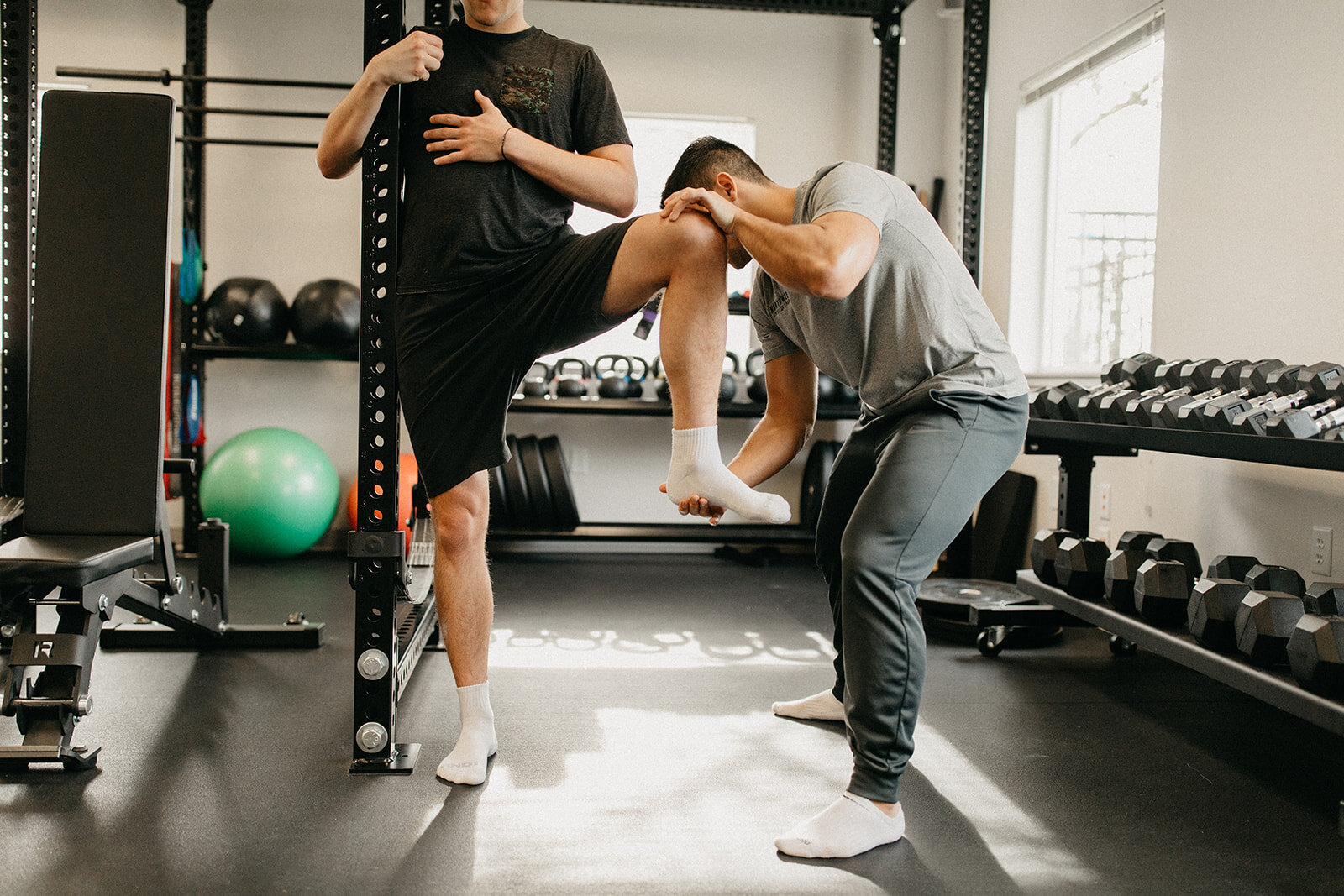 A Mobility Specialist helping a patient engage in a hip stretch at Northwest Spine and Sport in McMinnville, Oregon.
