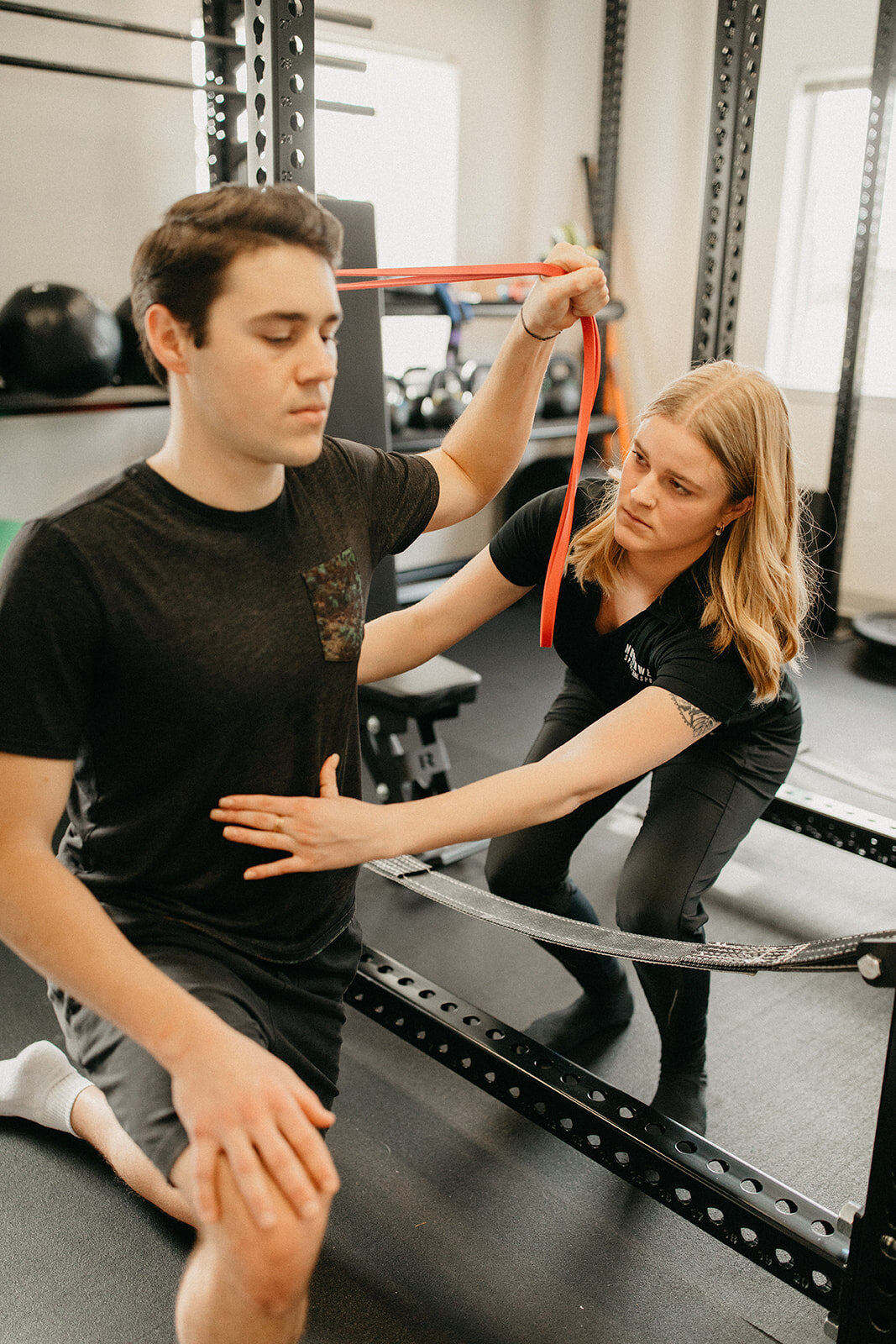 A Mobility Specialist helping a patient engage in a shoulder stretch at Northwest Spine and Sport in McMinnville, Oregon.