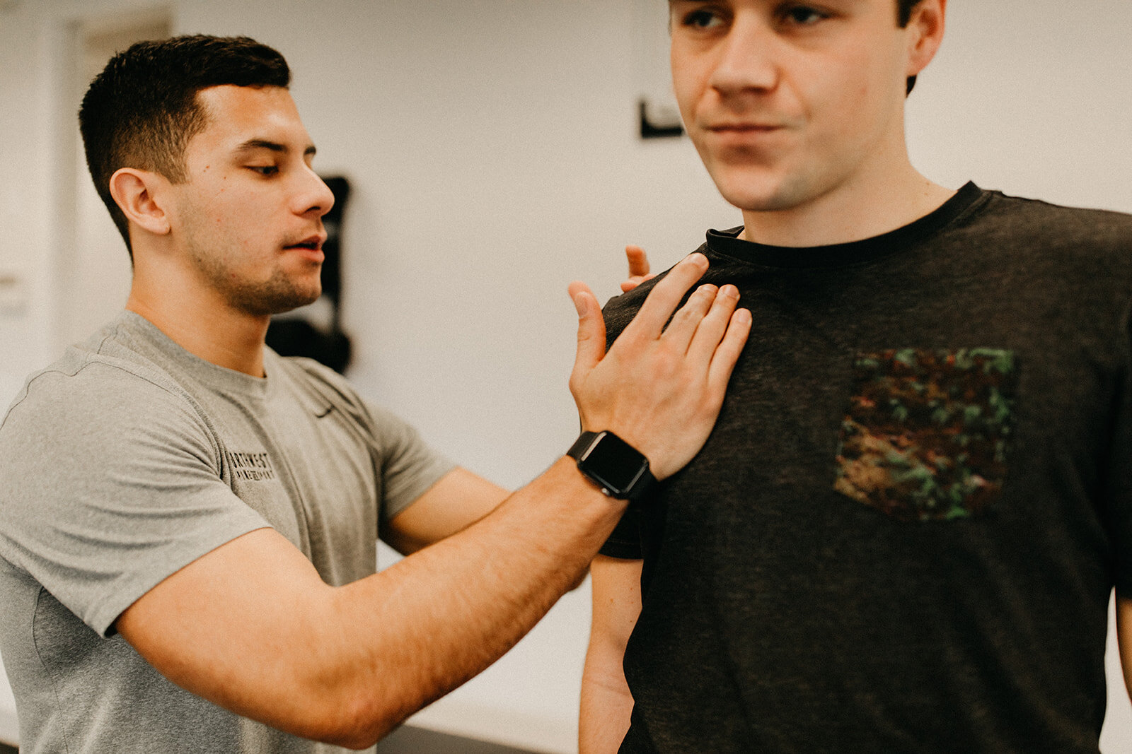 A Mobility Specialist at Northwest Spine and Sport helping a patient improve their shoulder mobility.