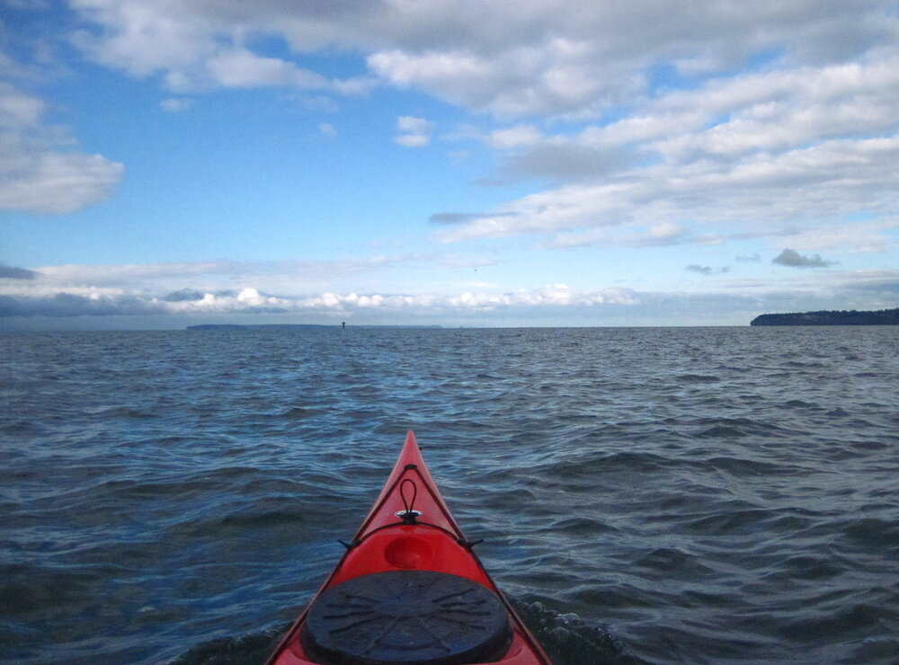 Paddling toward Kwomais Point. The near landmass on the right is Kwomais; the distant landmass that looks like an island is actually Point Roberts.