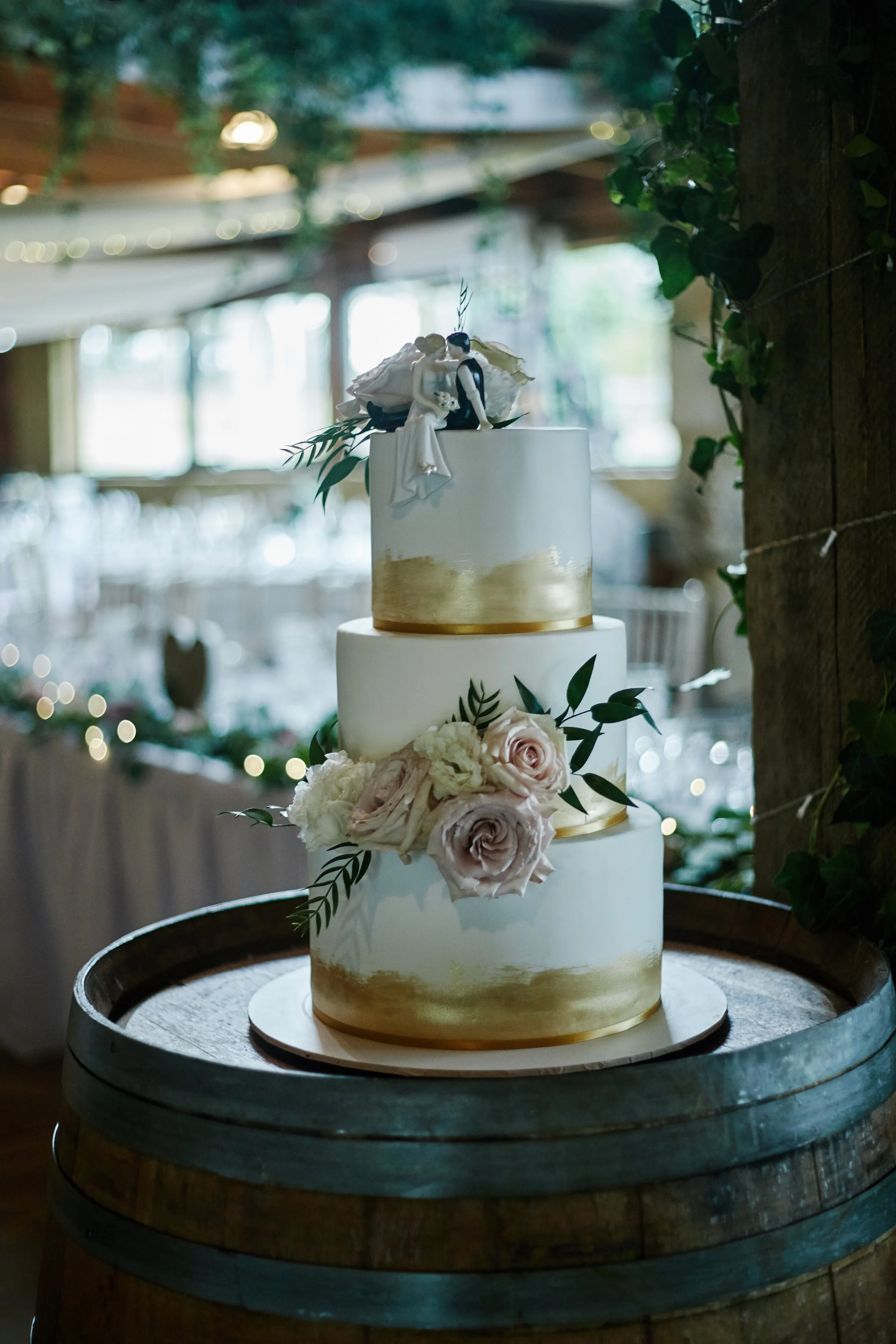 3 tier white and gold wedding cake. Photography by White Lane Studio