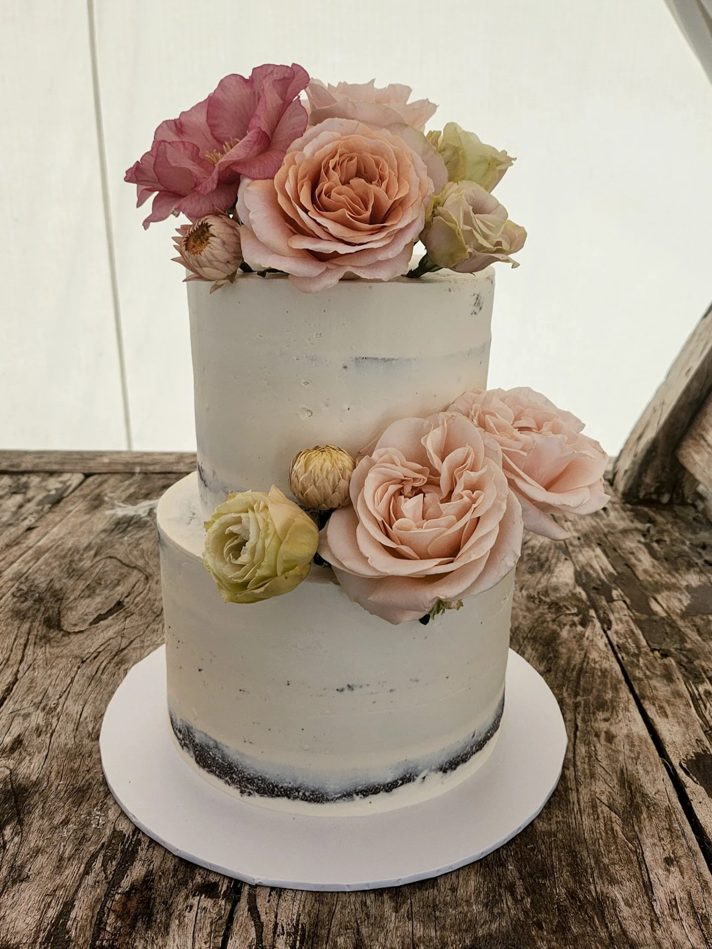 For Alice &amp; Ashley&rsquo;s celebration, I created a beautiful semi-naked cake in irresistible chocolate &amp; White choc raspberry. Topped with soft, romantic florals from @theflowershopdungog

Three flavours, two tiers, and one unforgettable day