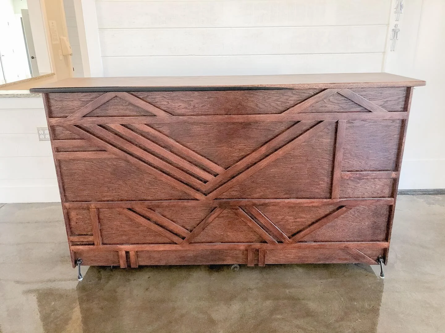 Another custom bar with a nod to mid-century modern style. With plenty of uses for floral or greenery accents in the spaced decorative wood on the front, custom styling becomes limitless!