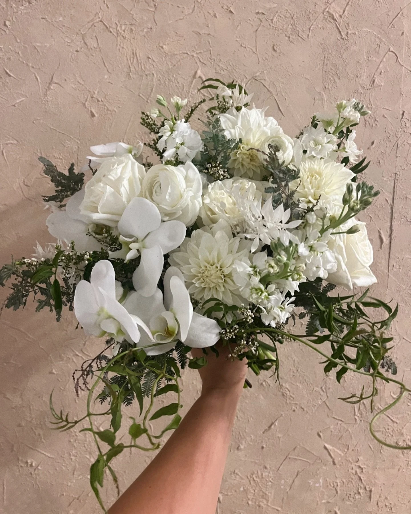 All-white bridal bouquet for K 🤍✨🌿 Featuring roses, dahlias, orchids with jasmine vines and wispy greens interwoven for a natural, romantic look.