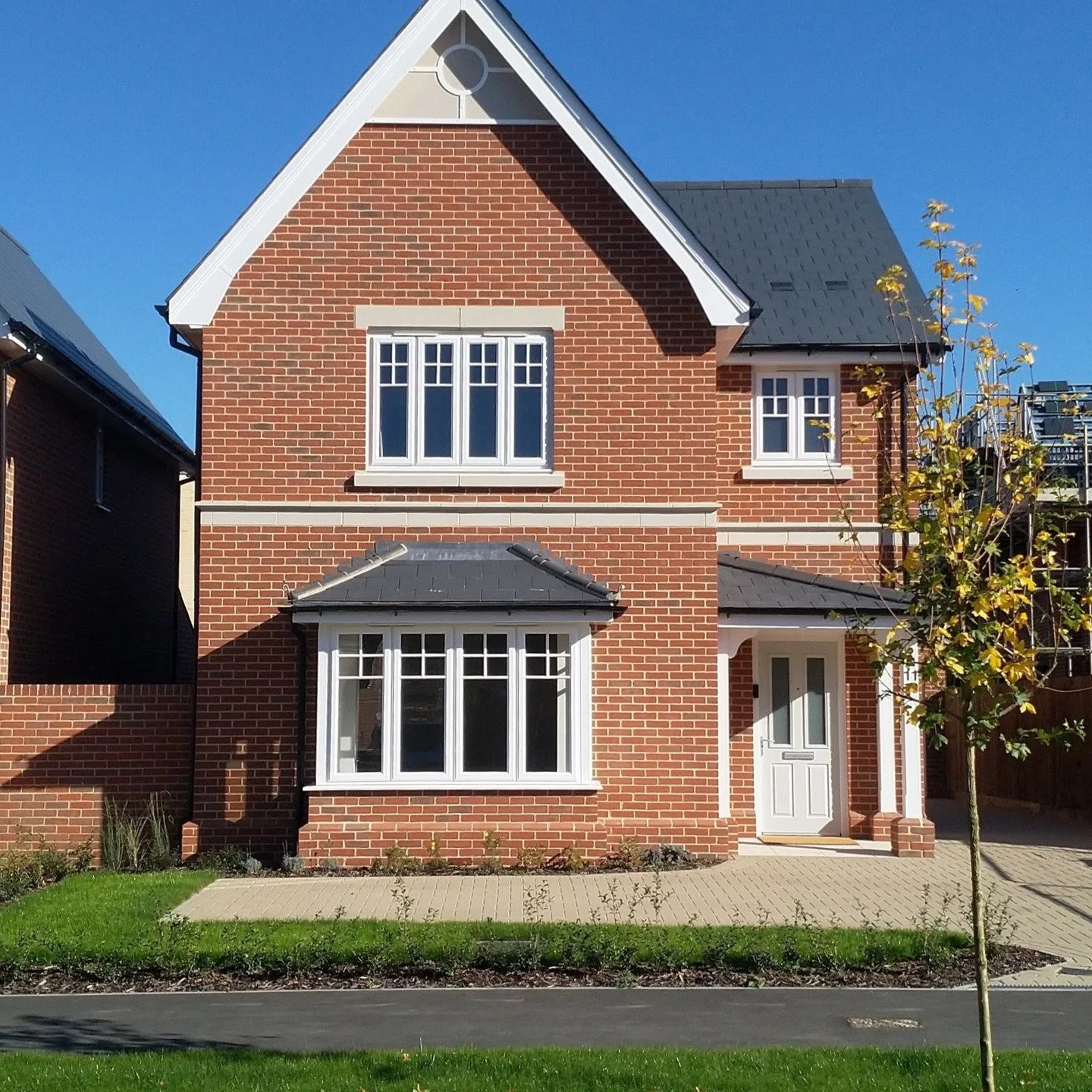 The Merlin at Chesterwell &mdash; a characterful home with a striking gable front, traditional materials, and carefully considered detailing. Set within a tree-lined street, it forms part of a rich and varied streetscape shaped by landscape and archi