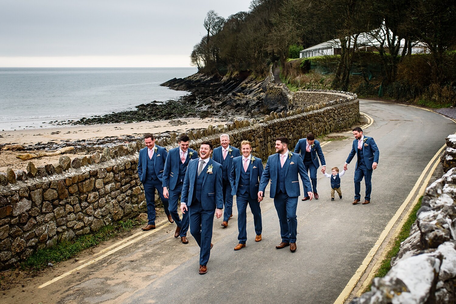 Groomsmen walk to Oxwich Bay Hotel