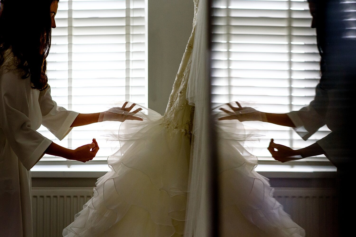 Bride fixes her wedding dress