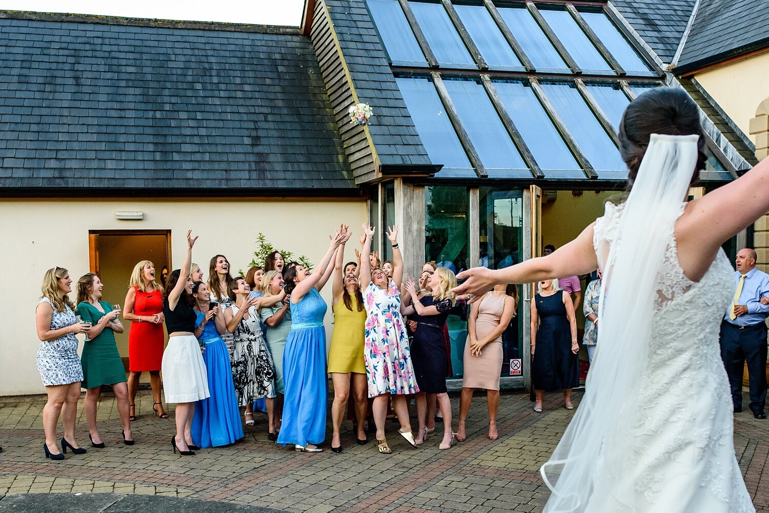 Throwing the bouquet at Rhosygilwen wedding 