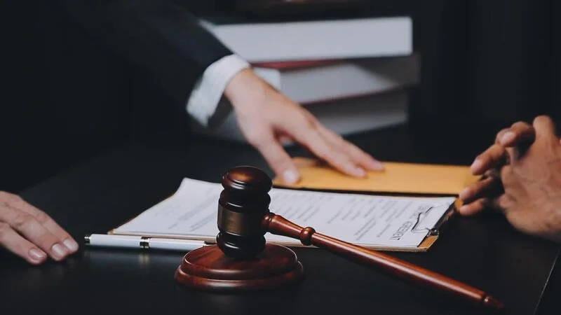 business-and-lawyers-discussing-contract-papers-with-brass-scale-on-desk-in-office-law-legal-services-advice-justice-and-law-concept-picture-with-film-grain-effect-video.jpg