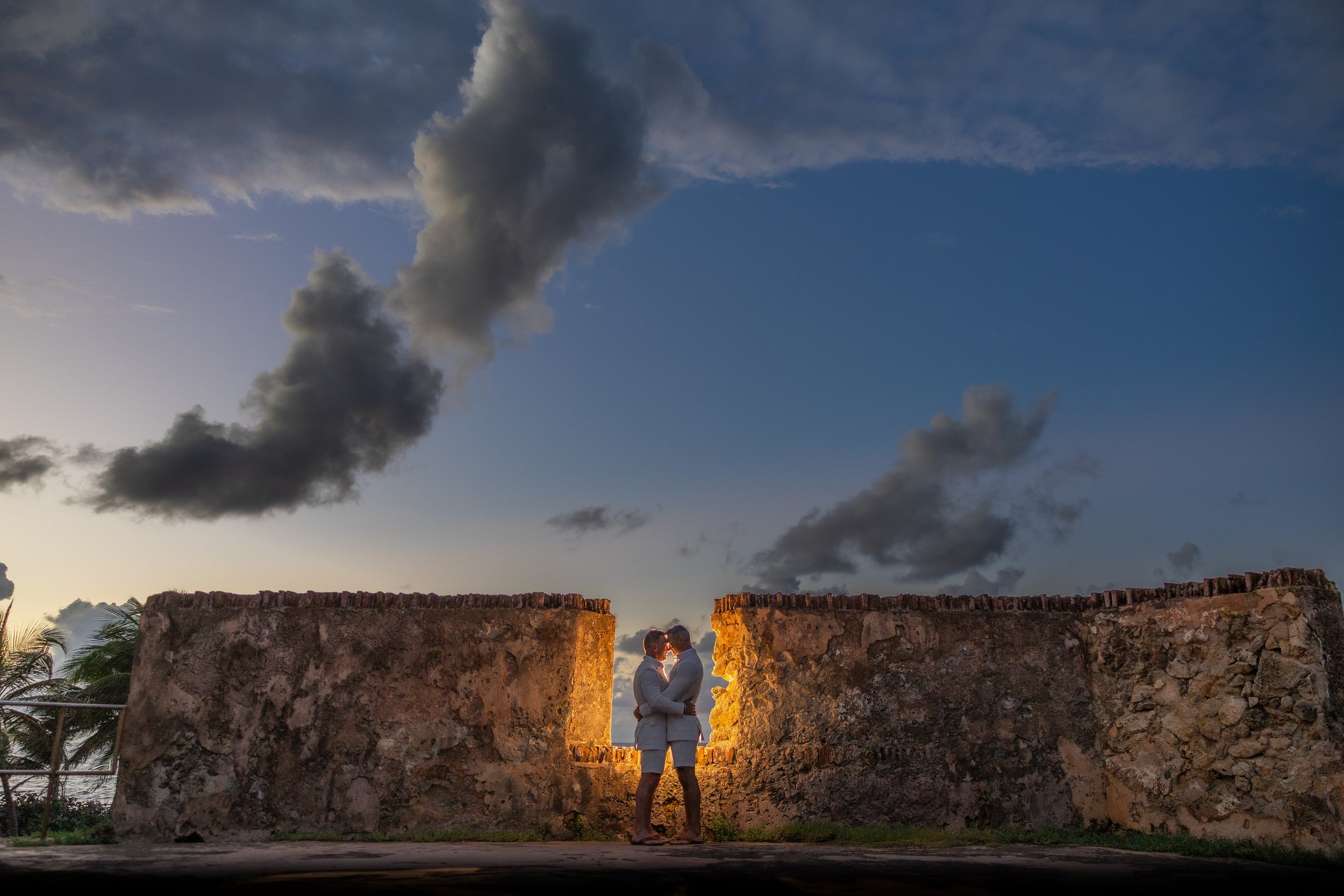 Grooms embracing during a gay elopement shot by an LGBT wedding photographer in Puerto Rico