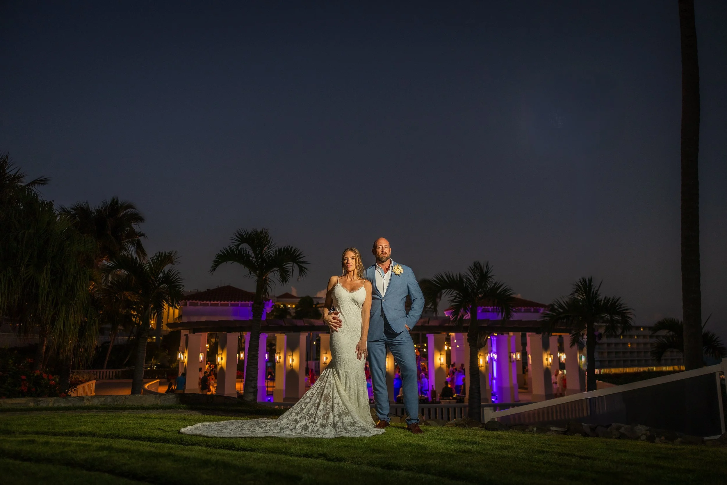 Bride and groom posing at El Conquistador Resort during golden hour taken by a wedding photographer in Puerto Rico