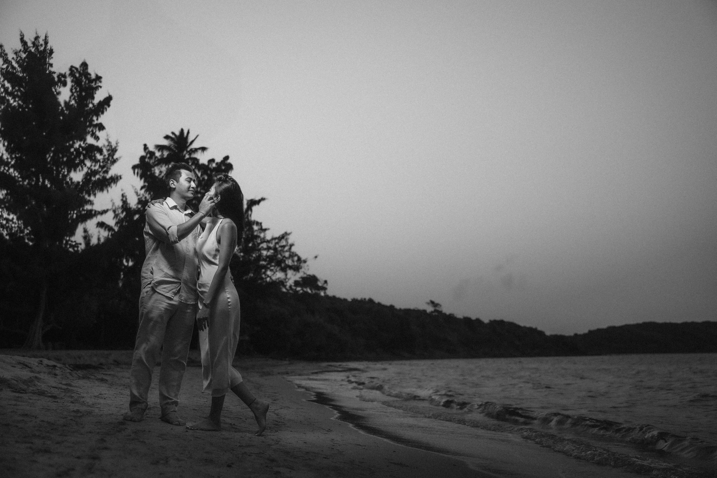 Romantic black and white portrait of Brijend and Sumi embracing during their destination marriage proposal at Seven Seas Beach in Fajardo, Puerto Rico.