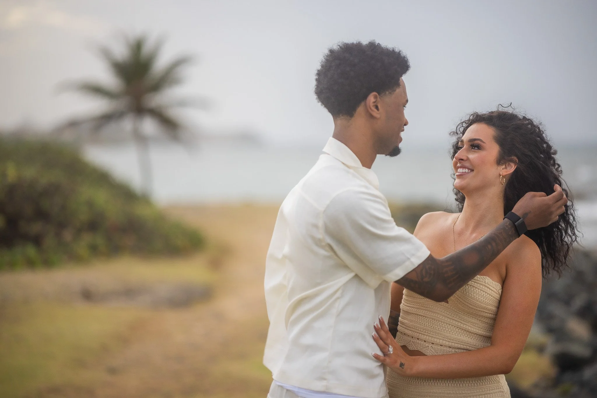 Newly engaged couple embracing at Escambrón Beach in Puerto Rico during the engagement session after their marriage proposal