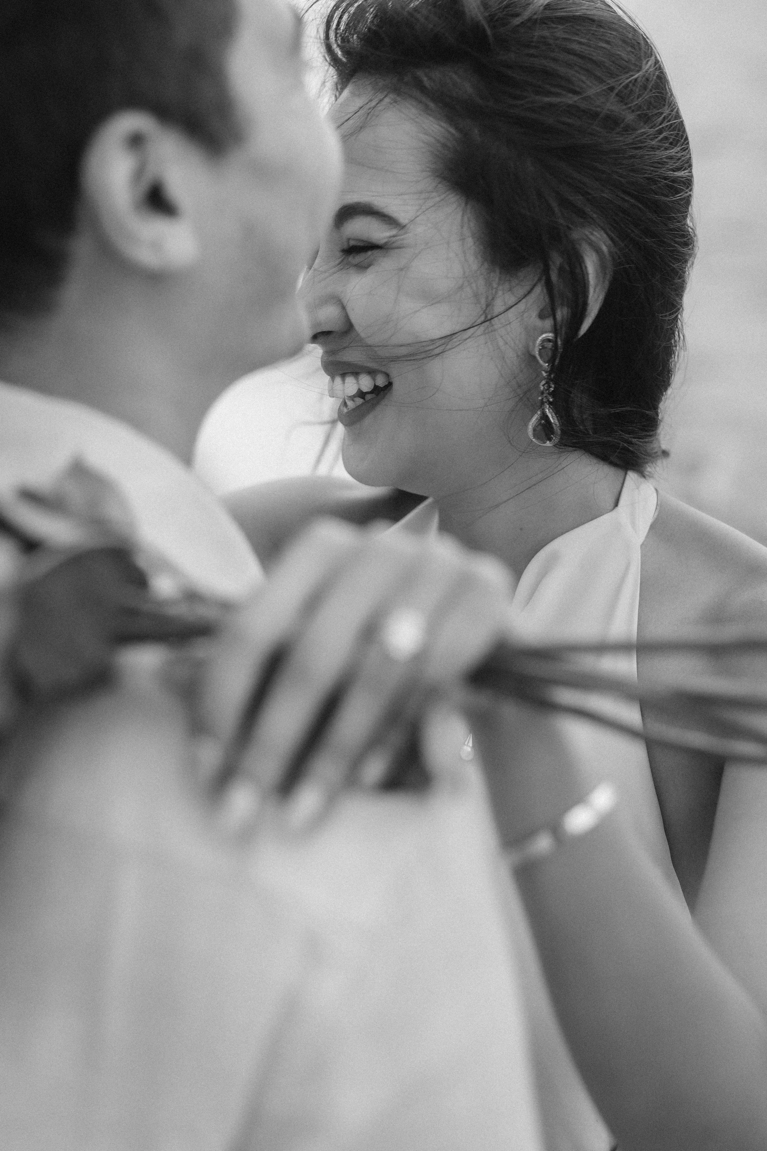 Intimate black and white portrait of Sumi laughing with Brijend during their luxury beach marriage proposal photography session in Puerto Rico.