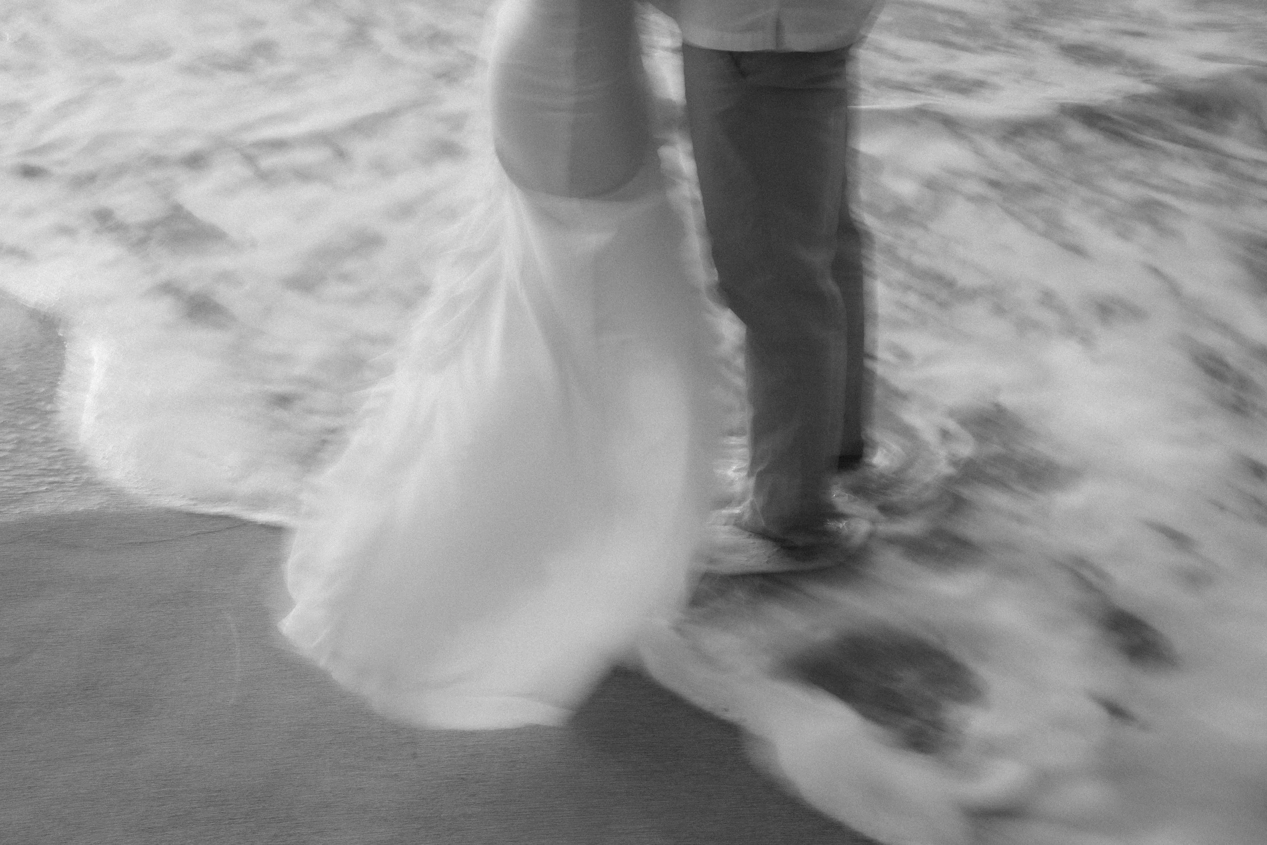 Trendy, blurry portrait of a newly engaged couple at Punta Borinquen Beach taken by a marriage proposal photographer in Puerto Rico