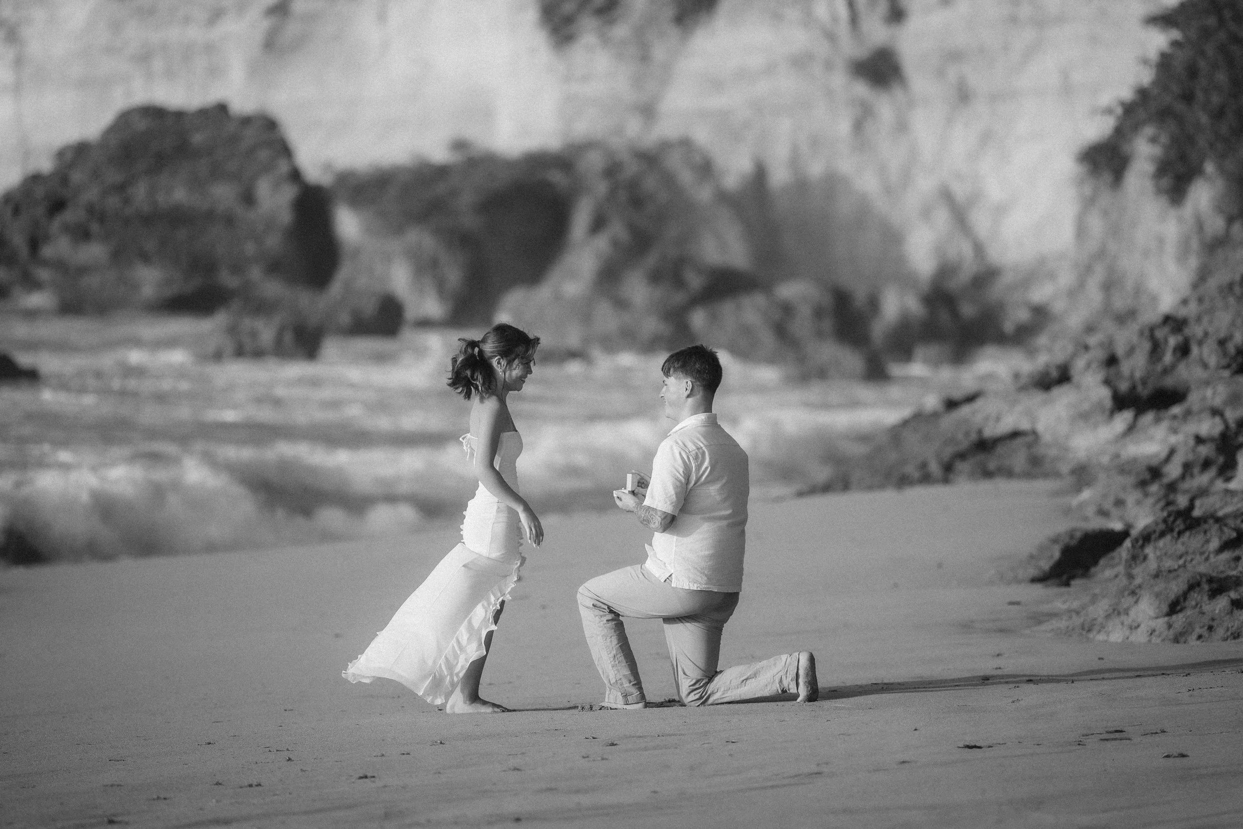 Man proposing to woman at Punta Borinquen Beach in Puerto Rico shot by a Puerto Rico destination wedding photographer