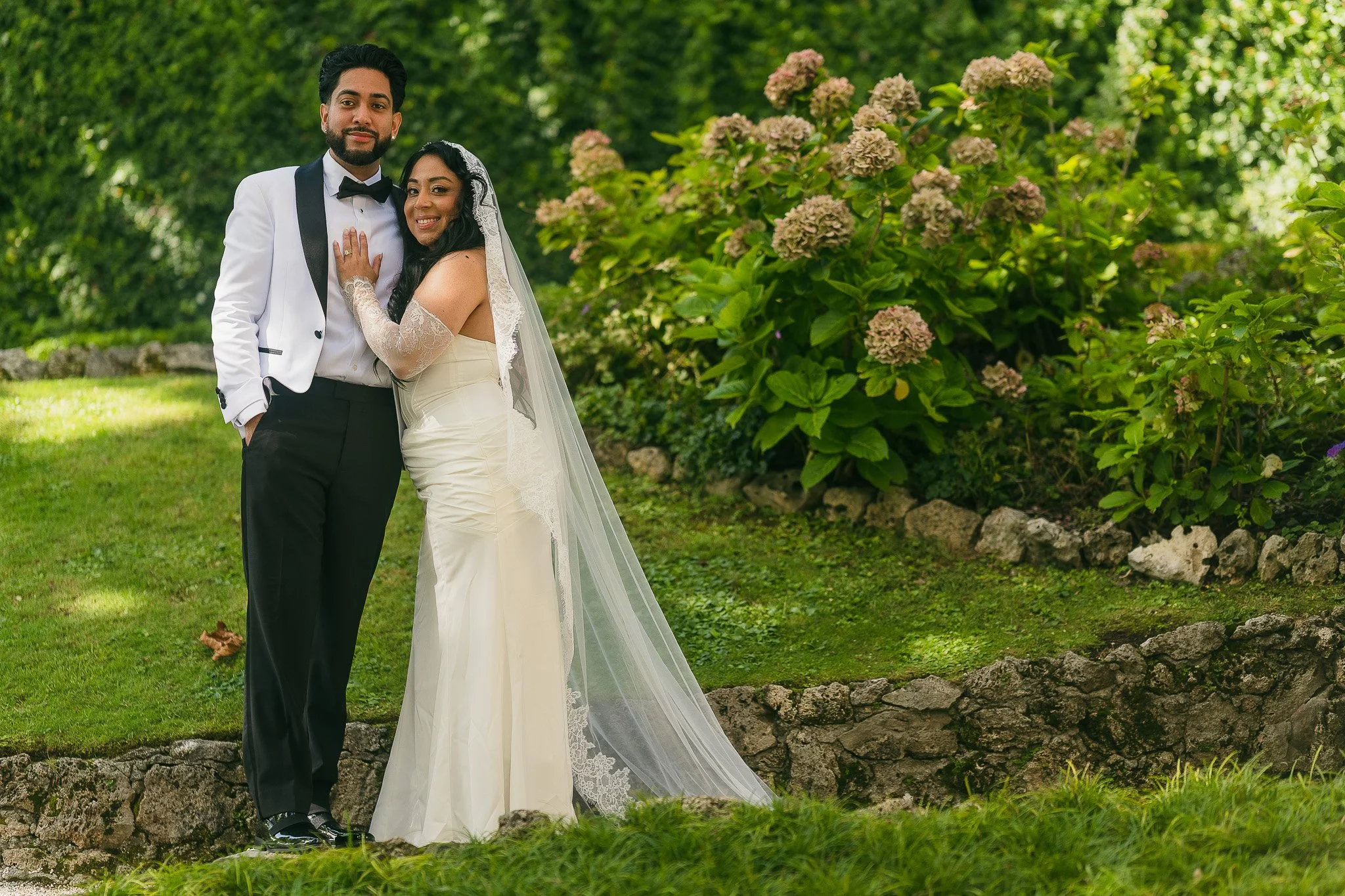 Bride and groom posing at Villa del Balbianello during their luxury, editorial elopement taken by a destination wedding photographer in Italy