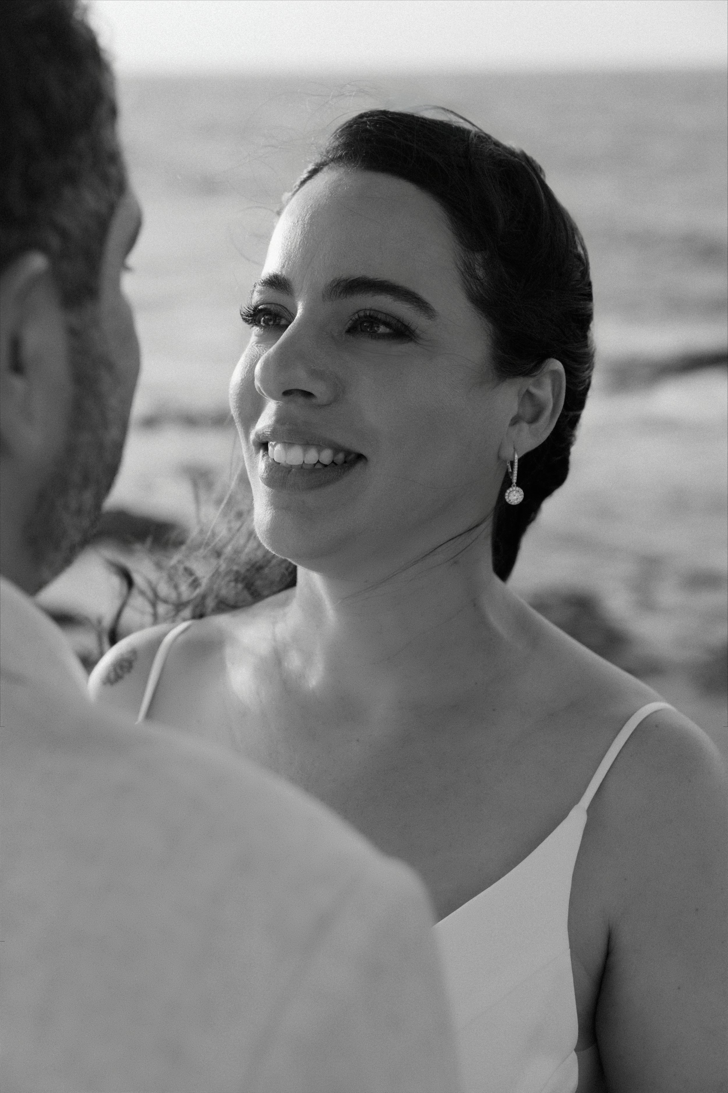 Bride gazing into groom's eyes during an intimate elopement in Puerto Rico at Escambrón Beach