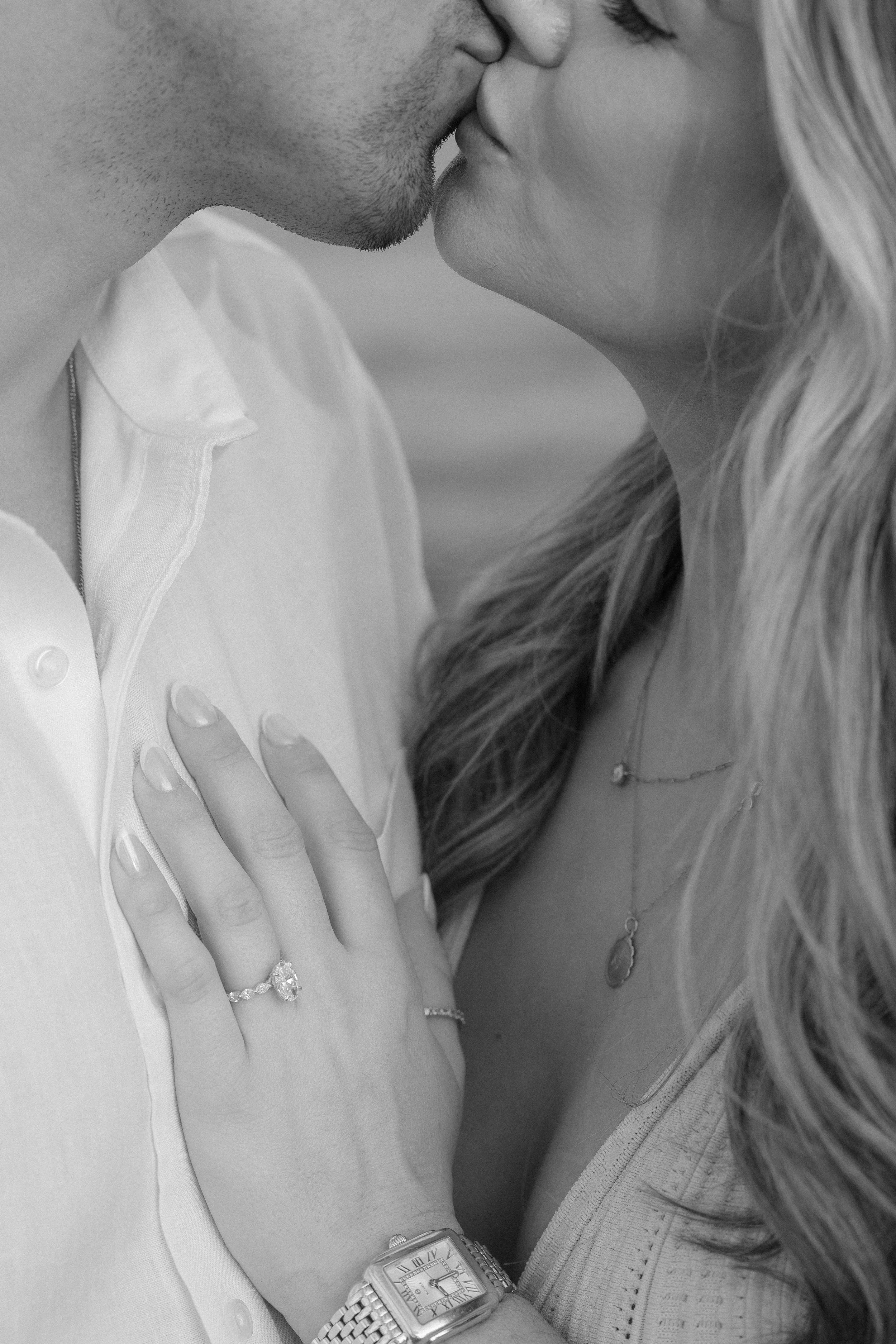 Black and white portrait of a couple kissing during their surprise marriage proposal in Puerto Rico taken by a destination wedding photographer