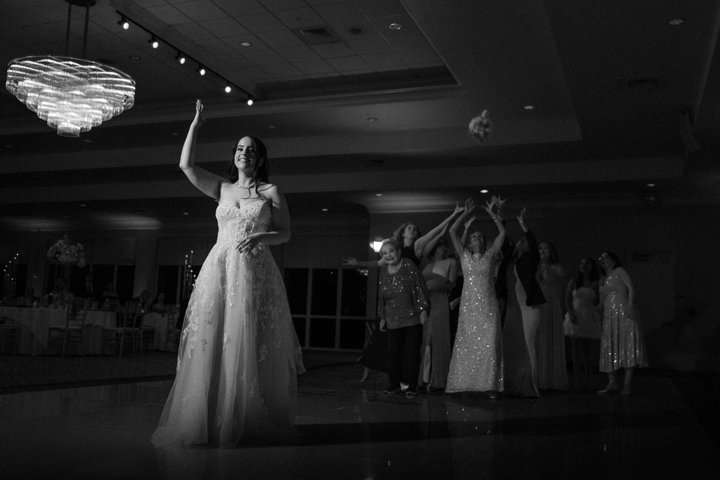 Bride tossing the bouquet at Indian Spring Country Club shot by a luxury wedding photographer in Florida