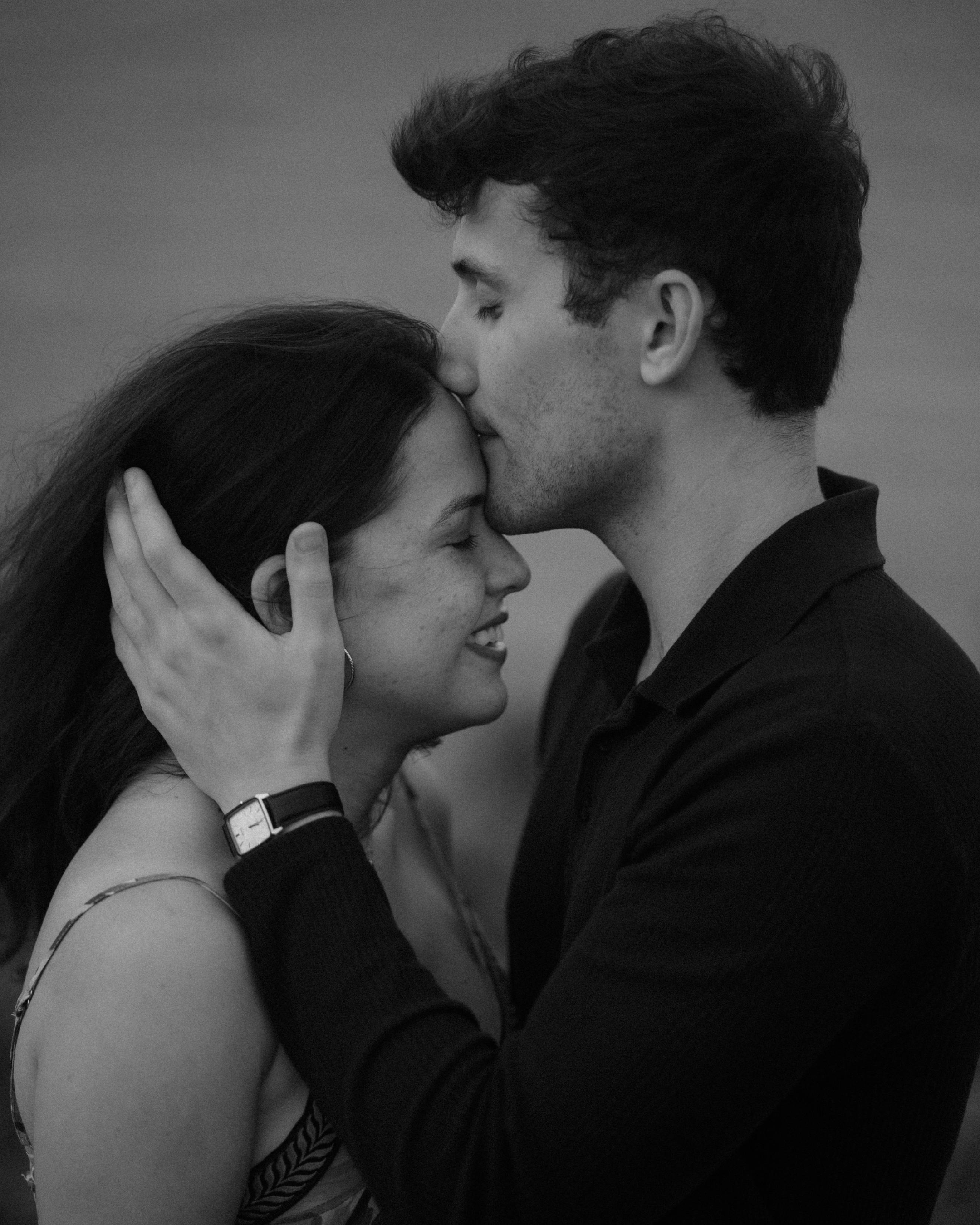 Black and white portrait of newly engaged couple embracing after a surprise proposal in Puerto Rico.