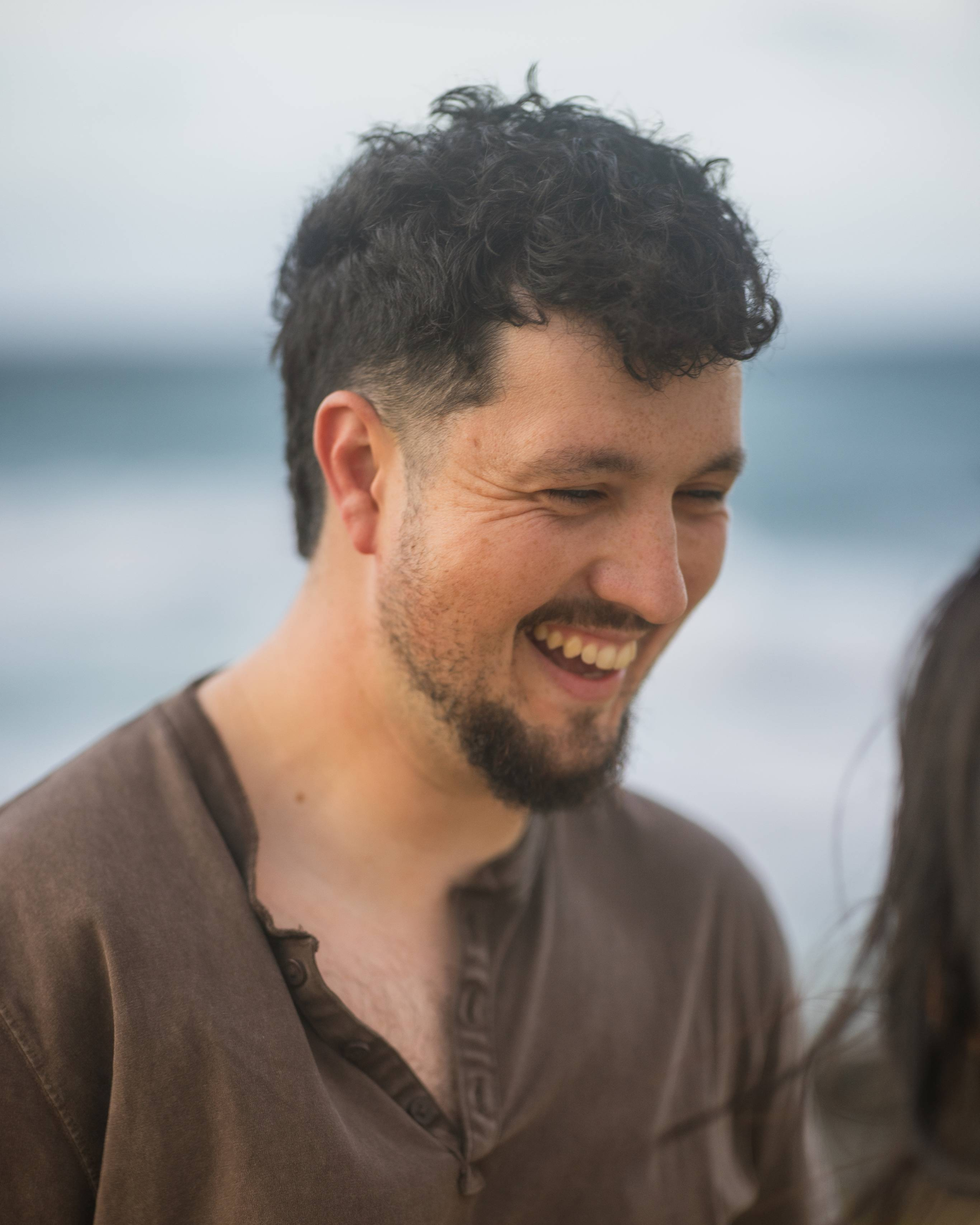 Couple embracing during romantic beach proposal at sunset in Puerto Rico