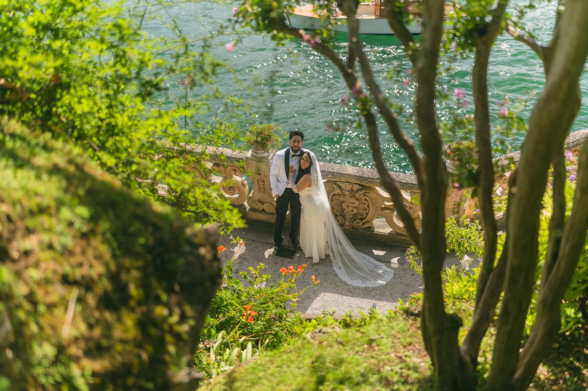 Bride and groom overlooking Lake Como from Villa del Balbianello during their luxury, editorial elopement taken by a destination wedding photographer