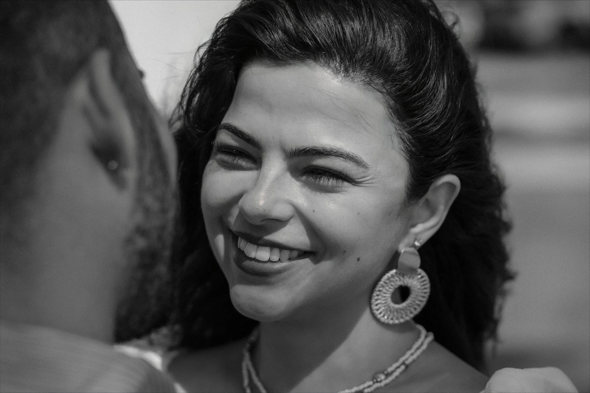 Editorial black and white portrait of a woman during the engagement session of her surprise marriage proposal in Escambrón Beach, Puerto Rico