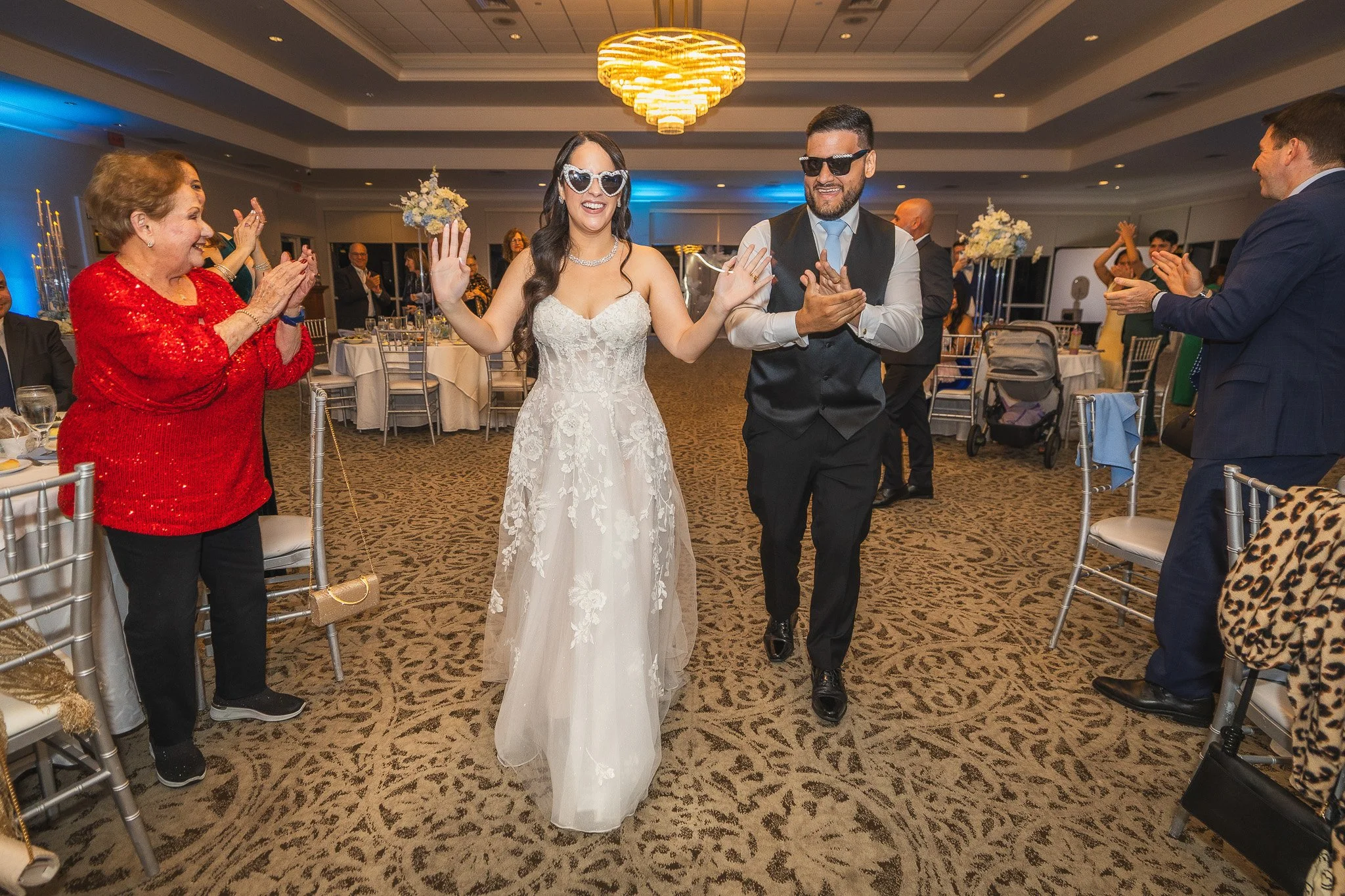 Bride and groom entering the reception hall during their wedding at Indian Spring Country Club in Boynton Beach, Florida
