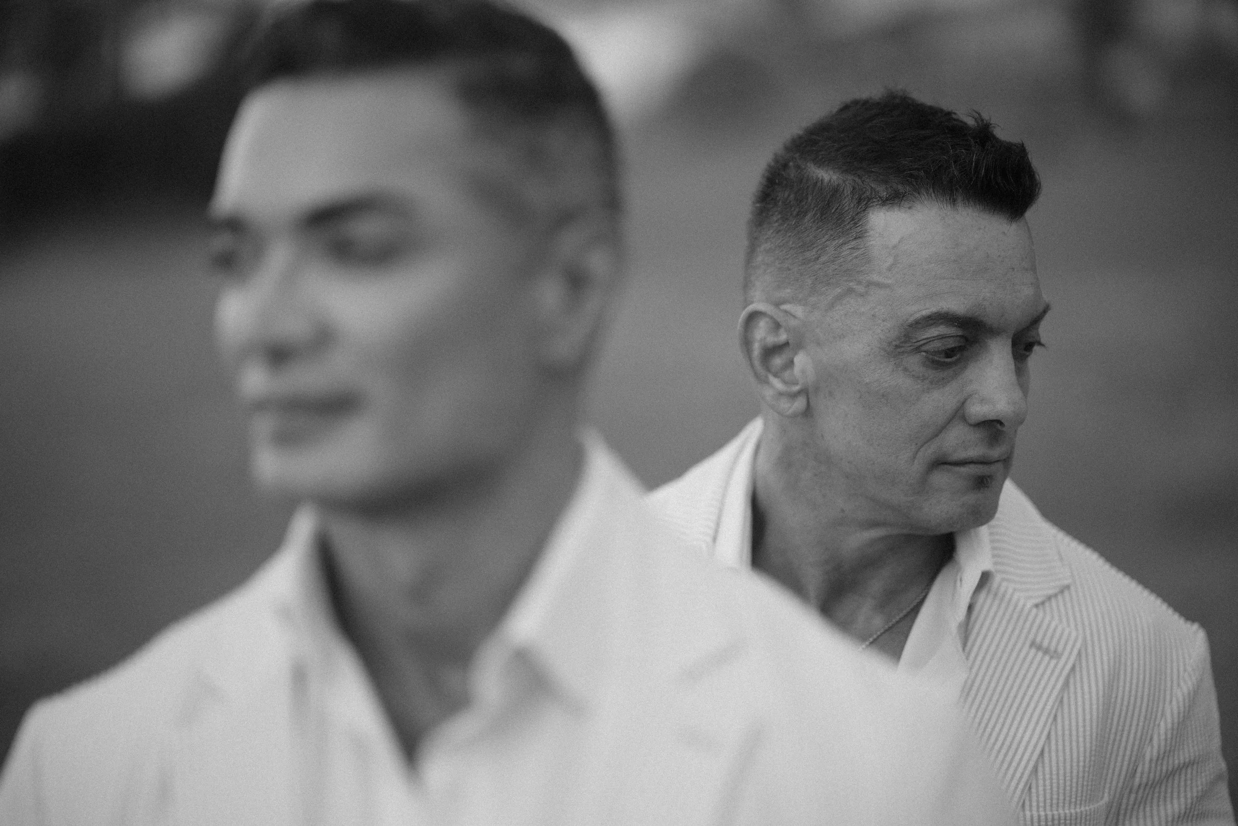 Grooms posing for an LGBT wedding photographer in Puerto Rico during their gay elopement at Escambrón Beach