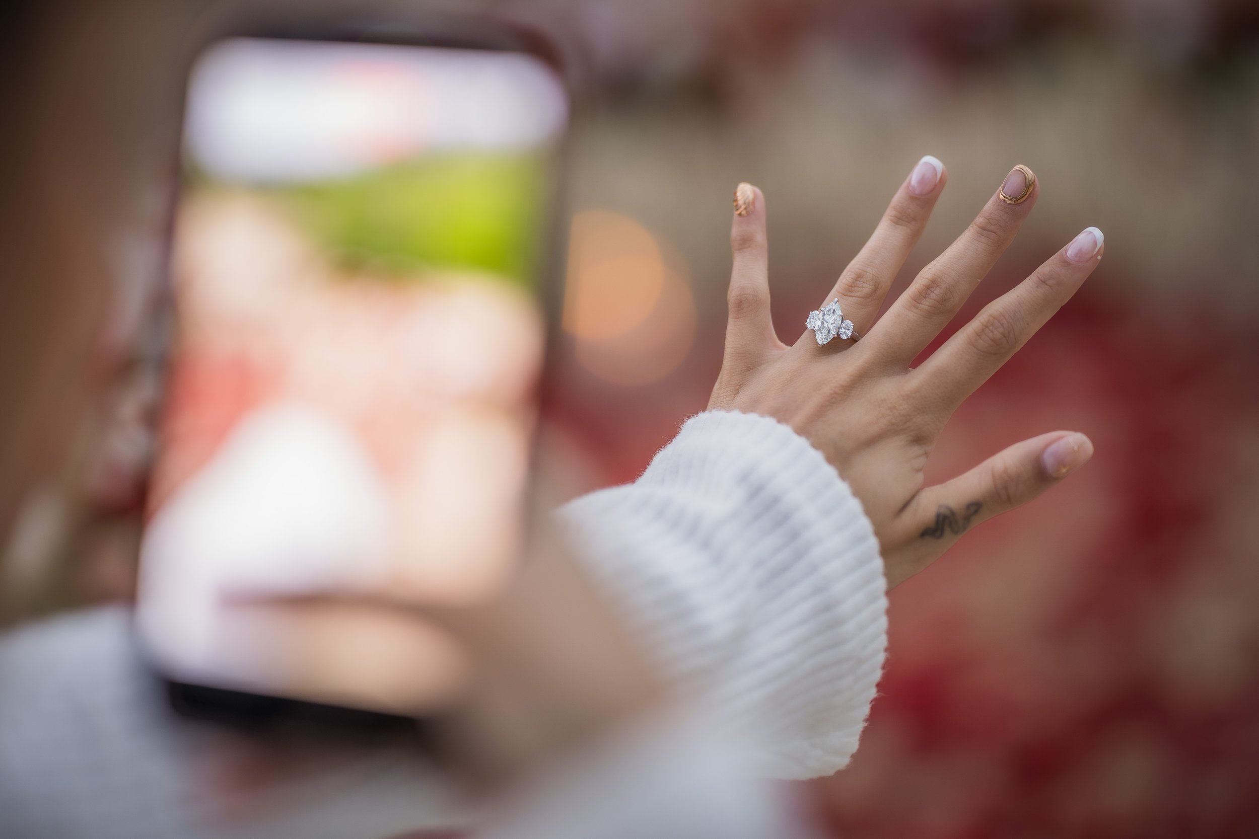 Woman taking a picture of her engagement ring at the Hyatt Regency Grand Reserve after a marriage proposal