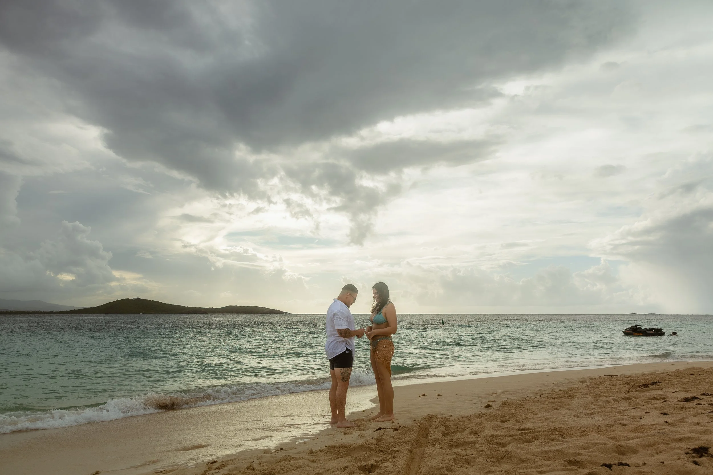 Man embracing woman during a marriage proposal in Icacos Island, Puerto Rico