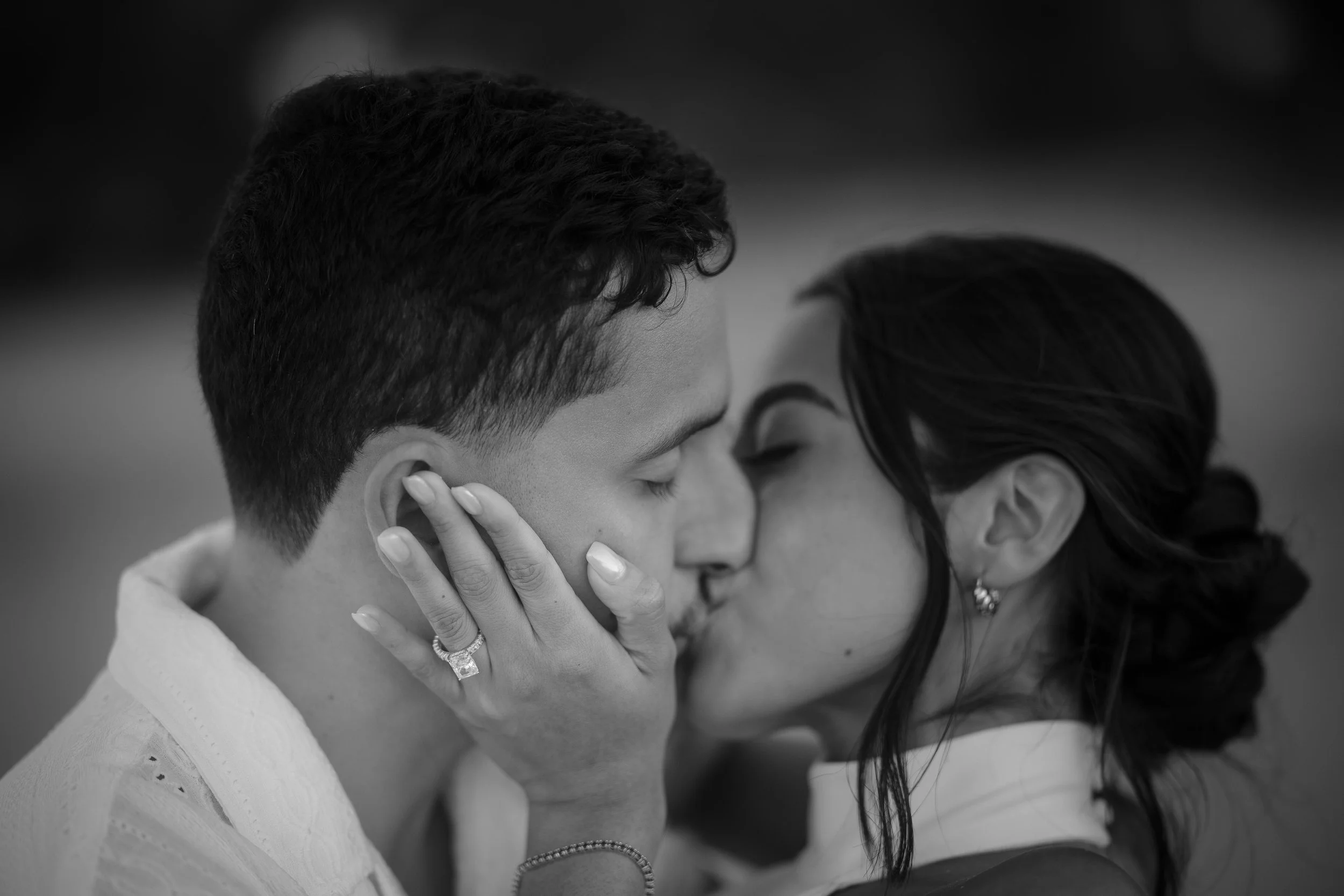 Black and white portrait of a couple kissing during their engagement session taken by a Puerto Rico marriage proposal photographer