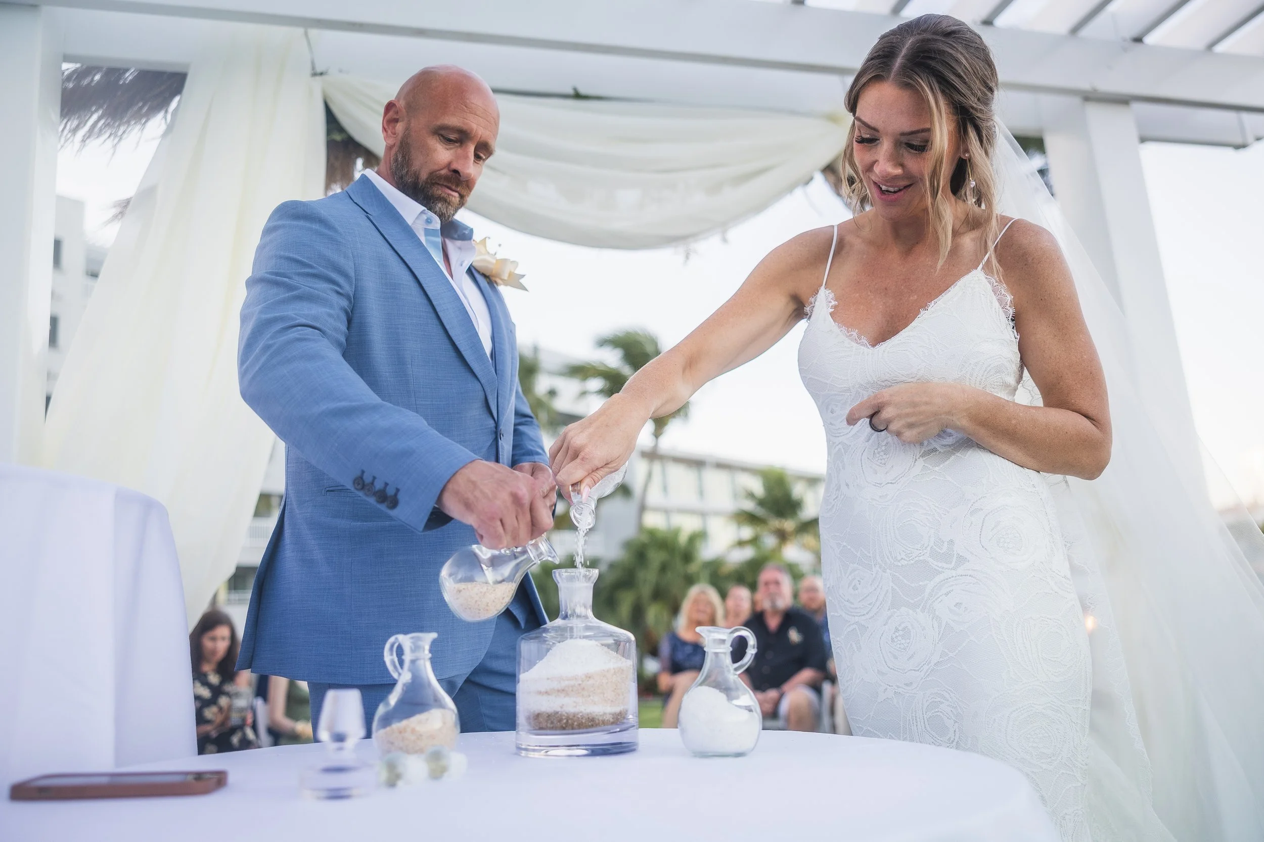 Bride and groom during sand ceremony at El Conquistador Resort taken by a luxury wedding photographer in Puerto Rico