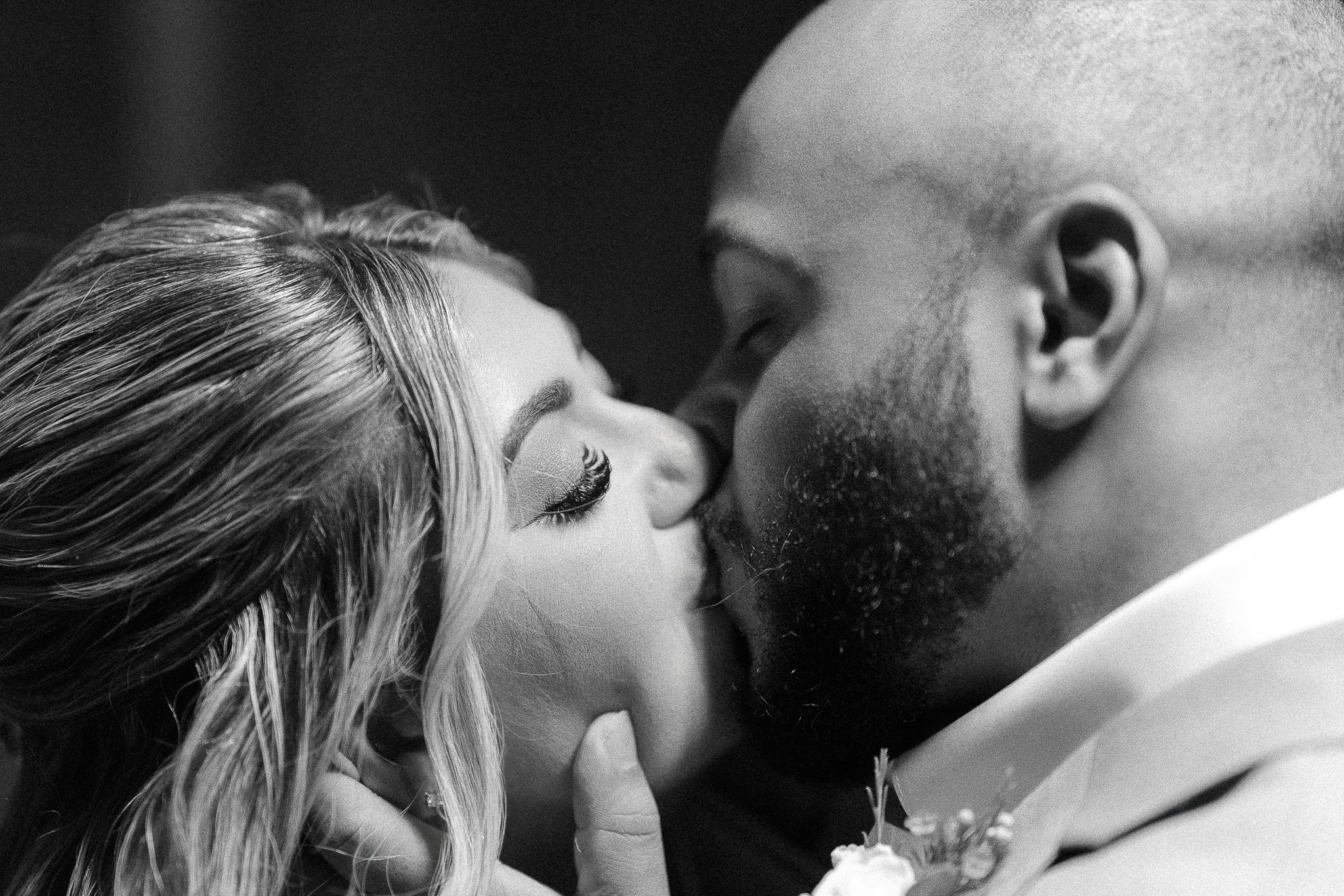 Editorial black and white portrait of a first kiss between the bride and groom during their elopement wedding in Puerto Rico