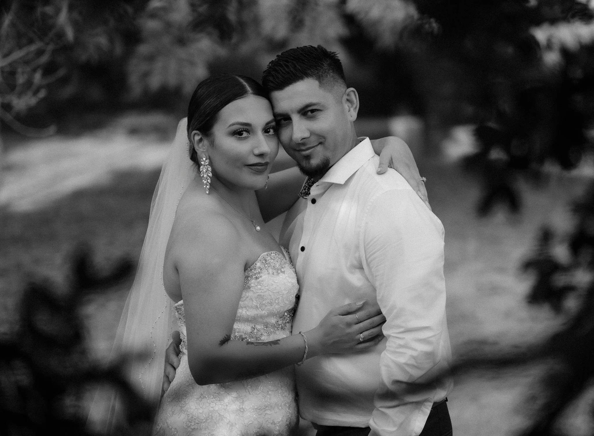 Black and white portrait of a bride and groom embracing during a luxury destination elopement in Old San Juan, Puerto Rico with soft natural framing.