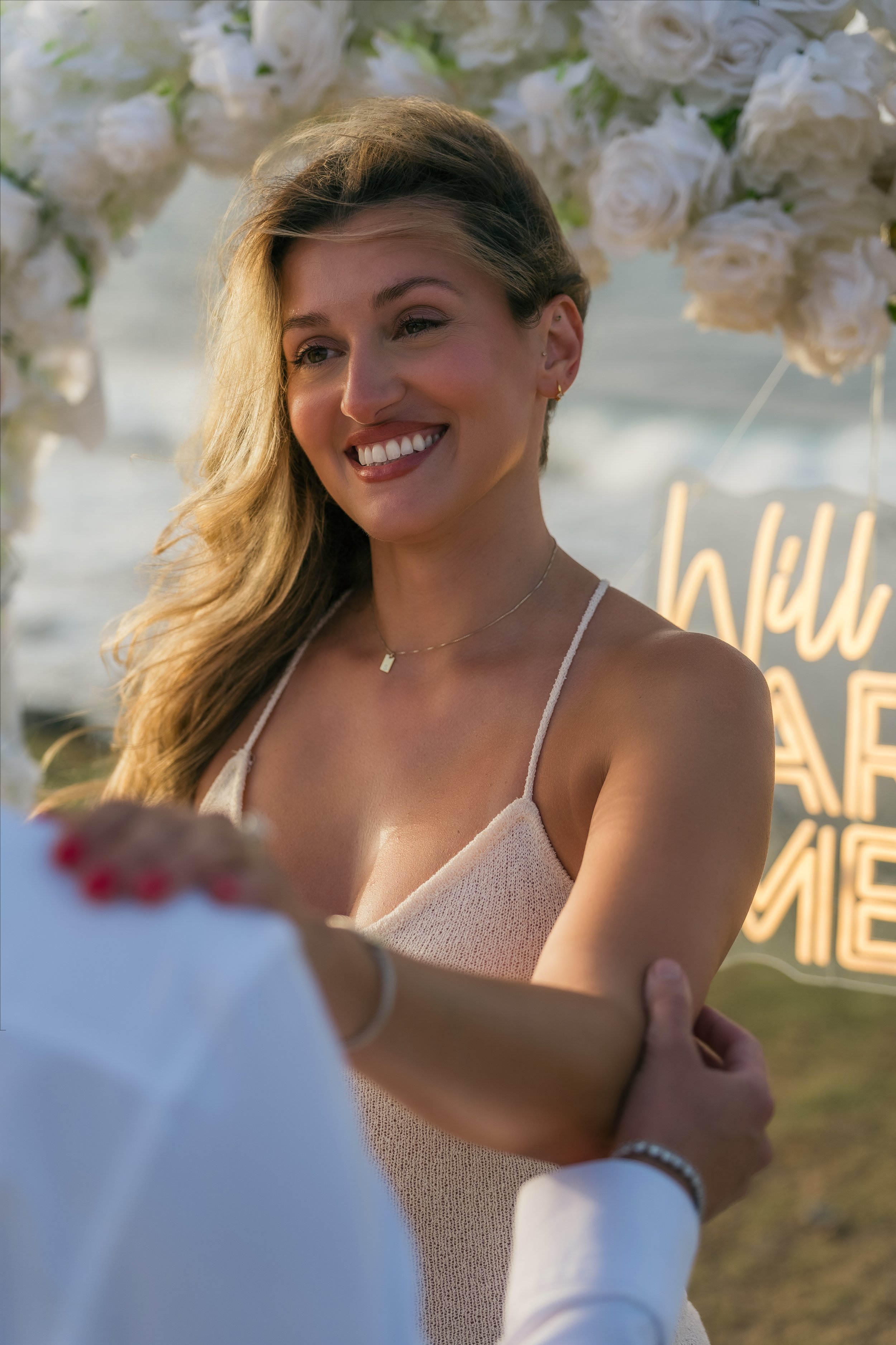 Woman smiling during her engagement session in Puerto Rico taken by a marriage proposal photographer at Escambrón Beach